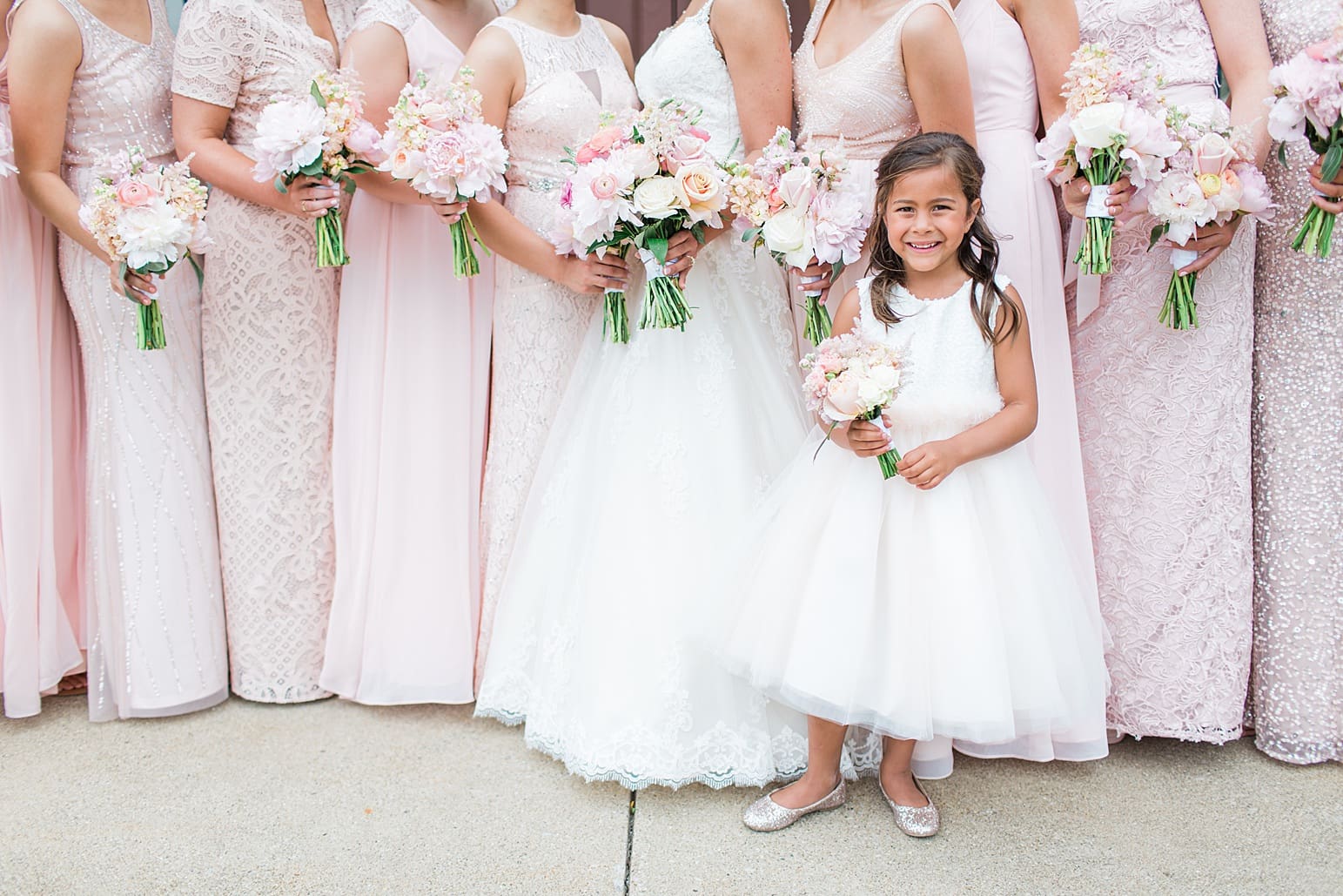 Arielle Peters Photography | Flower girl and bridesmaids outside large cathedral church on wedding day at First United Methodist Church in Mishawaka, Indiana.