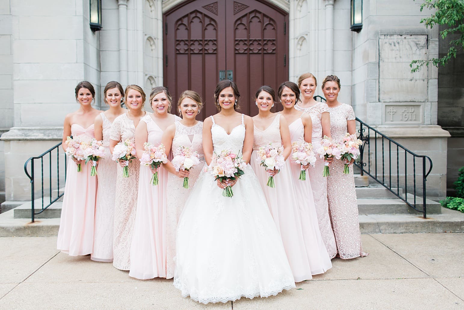 Arielle Peters Photography | Bride and bridesmaids outside large cathedral church on wedding day at First United Methodist Church in Mishawaka, Indiana.