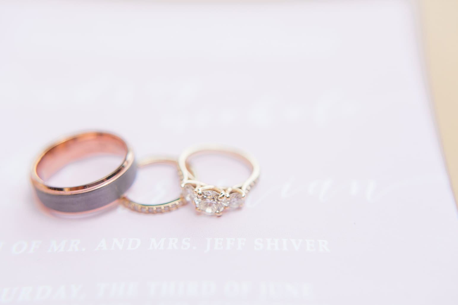 Arielle Peters Photography | Wedding rings lying on invitation on wedding day at First United Methodist Church in Mishawaka, Indiana.