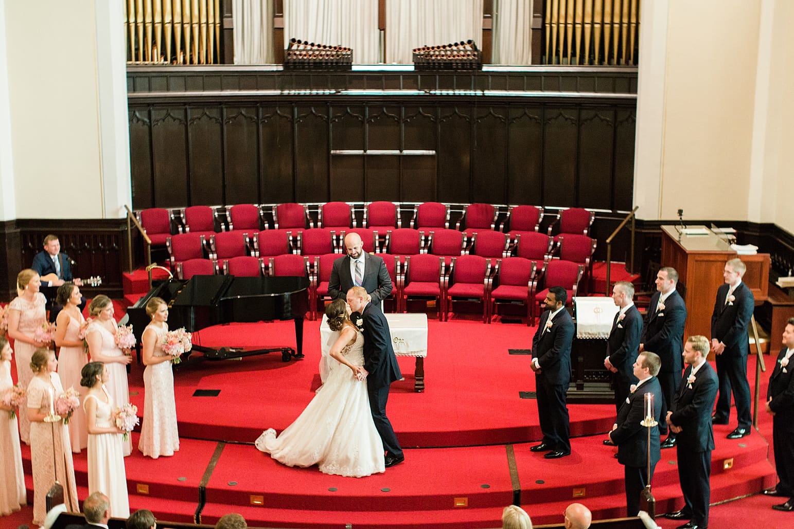 Arielle Peters Photography | Bride and groom kissing at the alter on wedding day at First United Methodist Church in Mishawaka, Indiana.