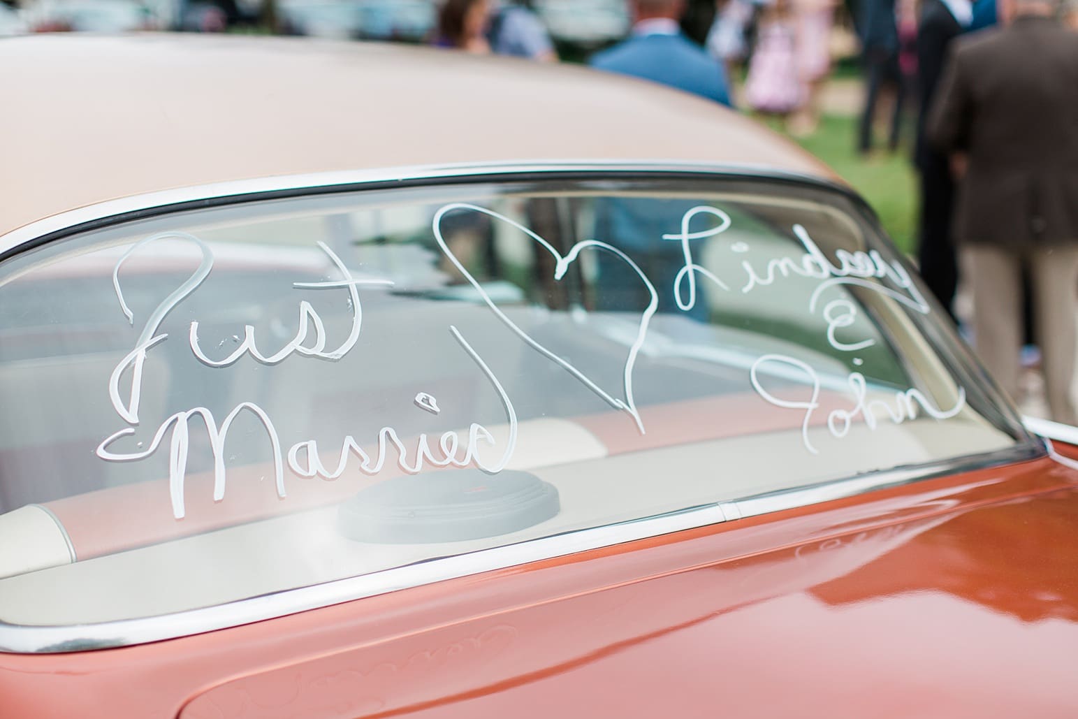 Arielle Peters Photography | Bride and groom driving away in vintage car on wedding day at First United Methodist Church in Mishawaka, Indiana.