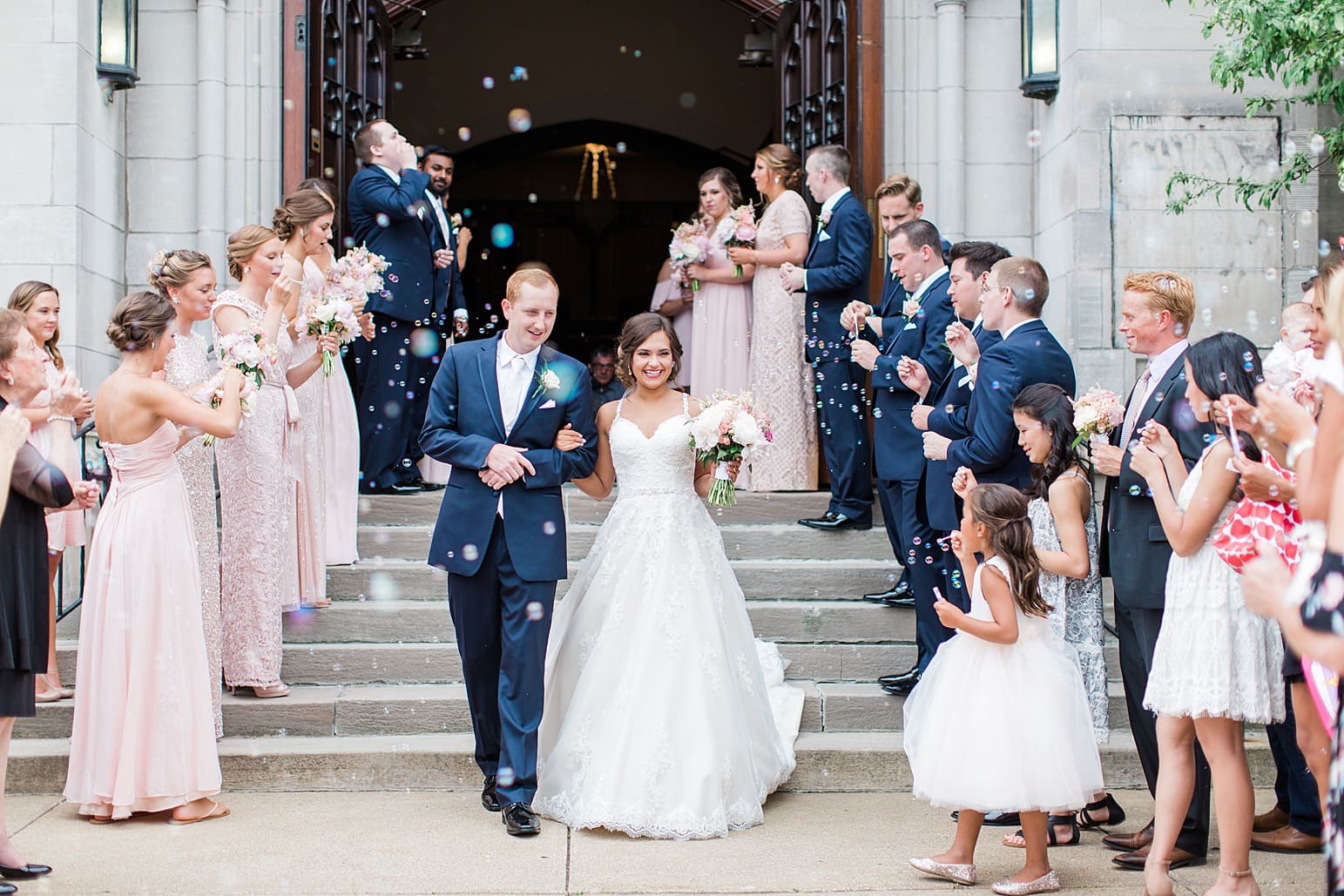 Arielle Peters Photography | Bride and groom walking out of cathedral doors on wedding day at First United Methodist Church in Mishawaka, Indiana.