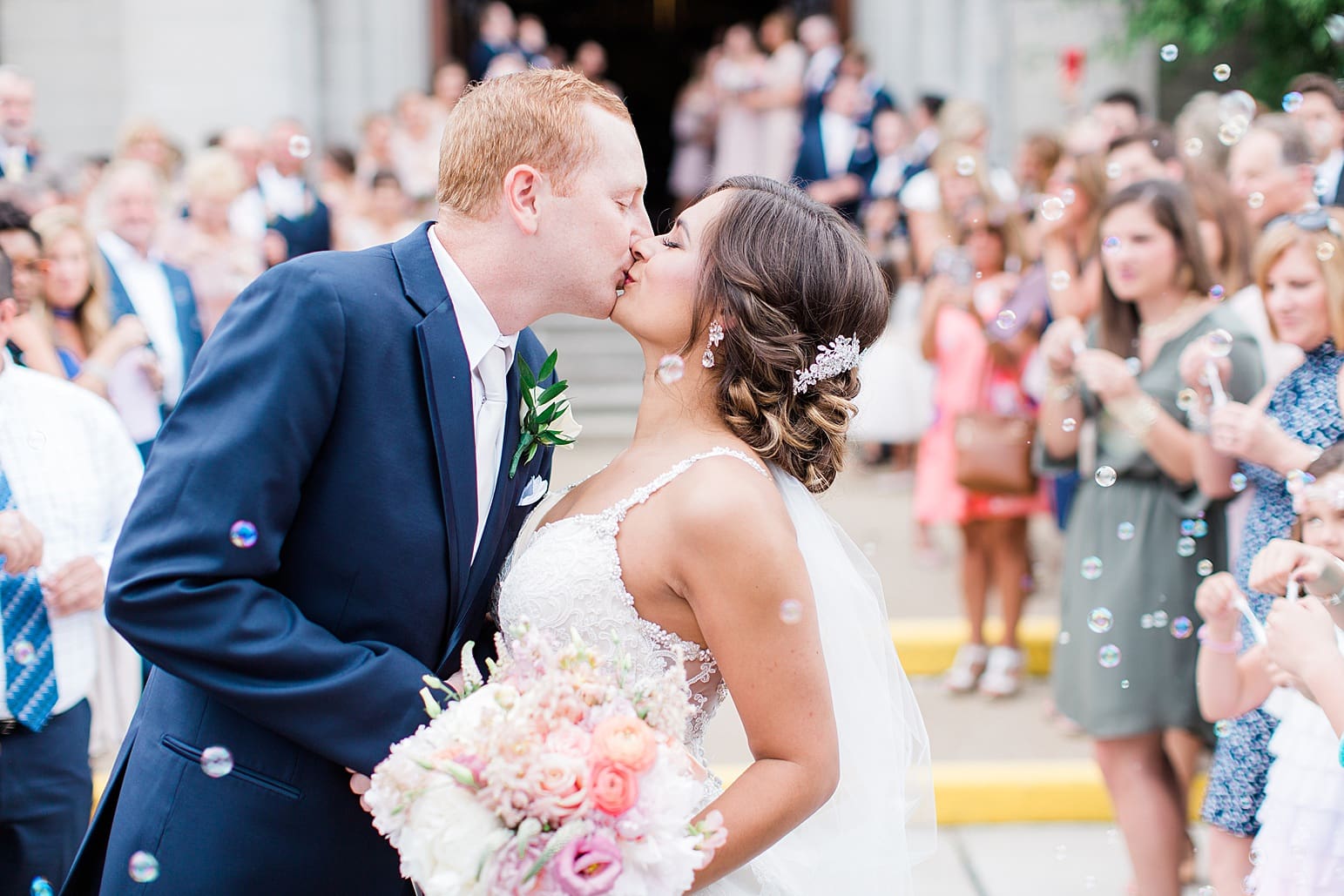 Arielle Peters Photography | Bride and groom kissing outside cathedral church on wedding day at First United Methodist Church in Mishawaka, Indiana.