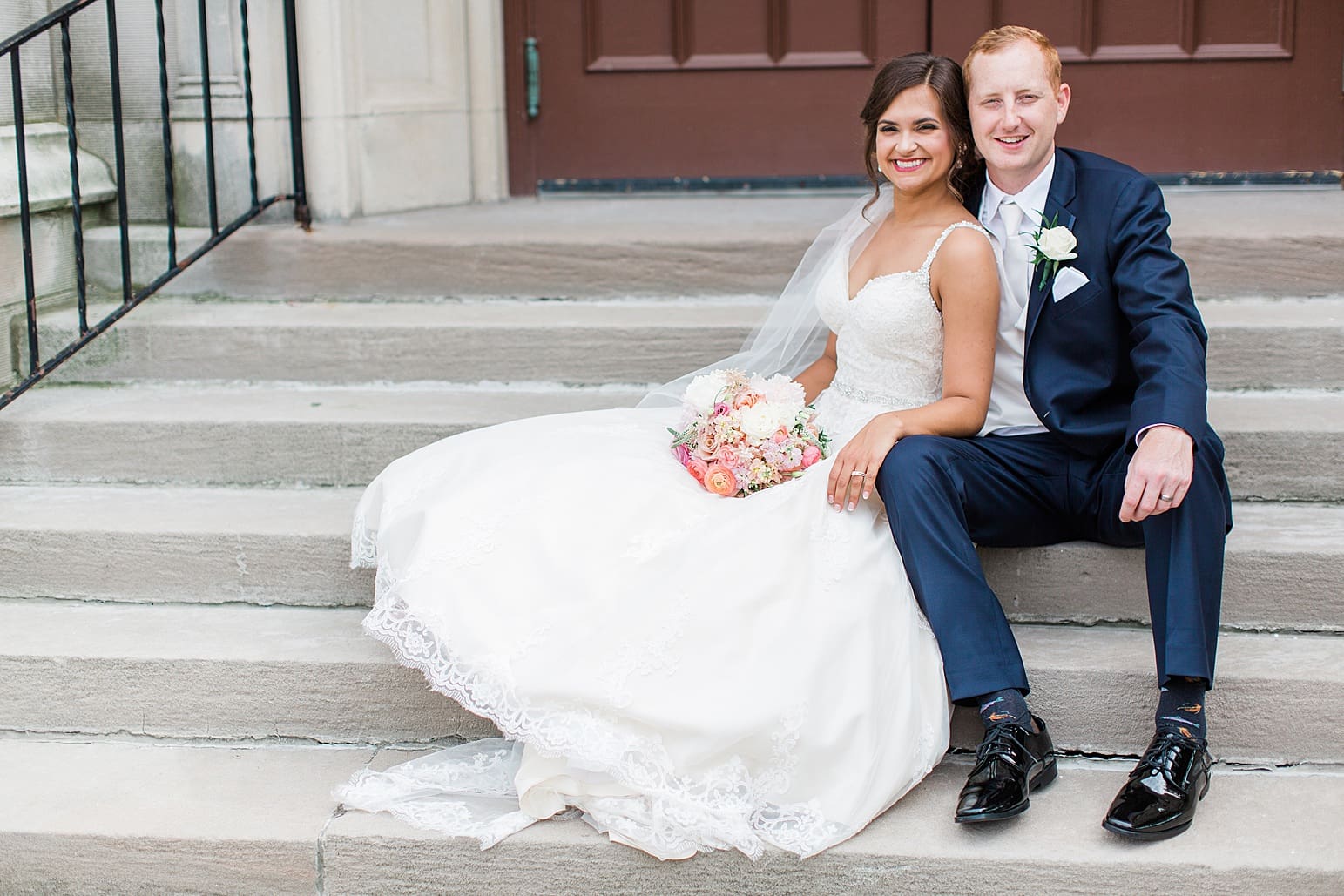 Arielle Peters Photography | Bride and groom sitting on cathedral church steps on wedding day at First United Methodist Church in Mishawaka, Indiana.