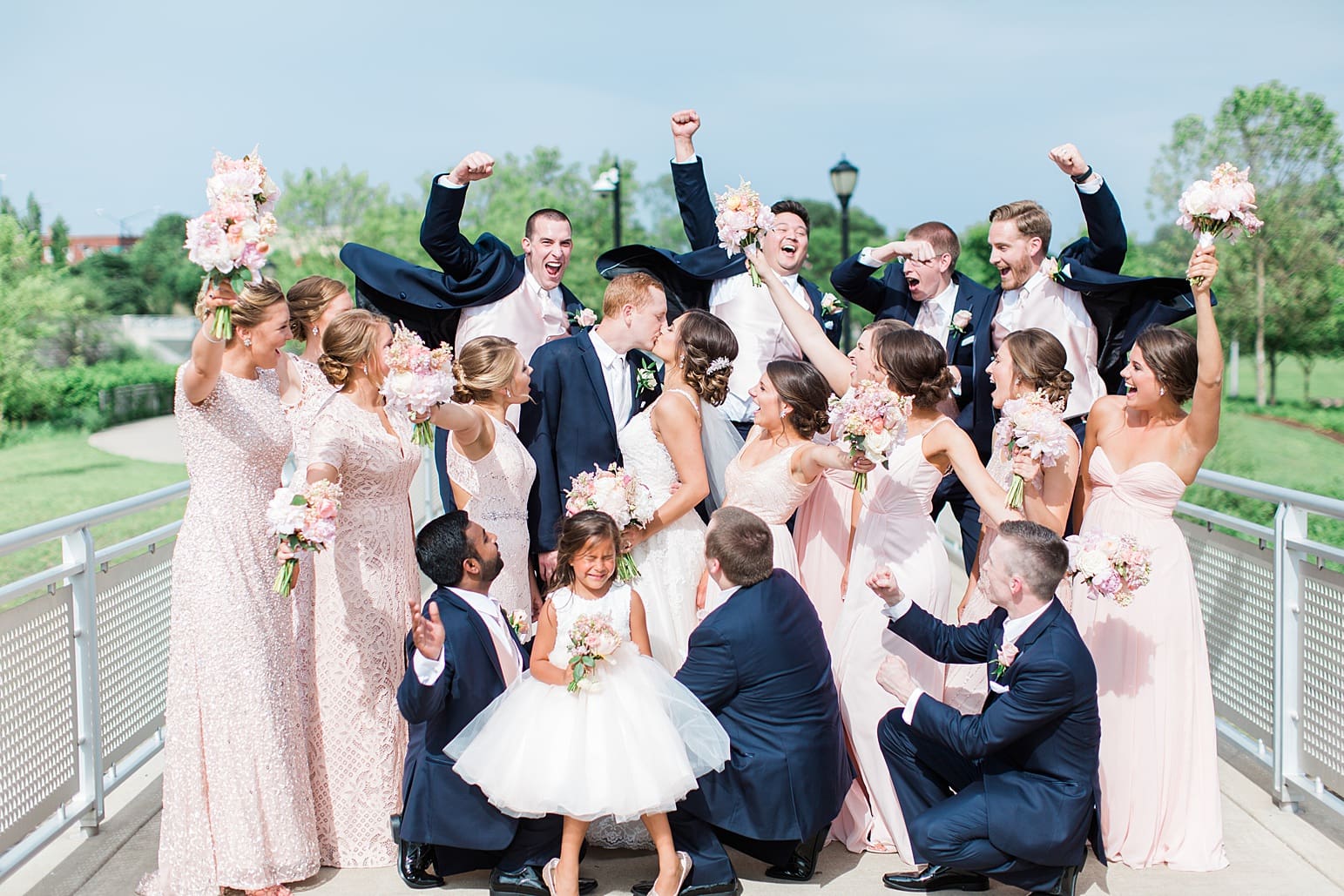 Arielle Peters Photography | Wedding party cheering on water bridge on wedding day at First United Methodist Church in Mishawaka, Indiana.