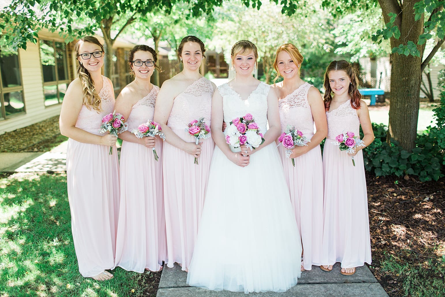 Arielle Peters Photography | Bride and bridesmaids outside under trees on wedding day at St. Joseph County Parks in South Bend, Indiana.