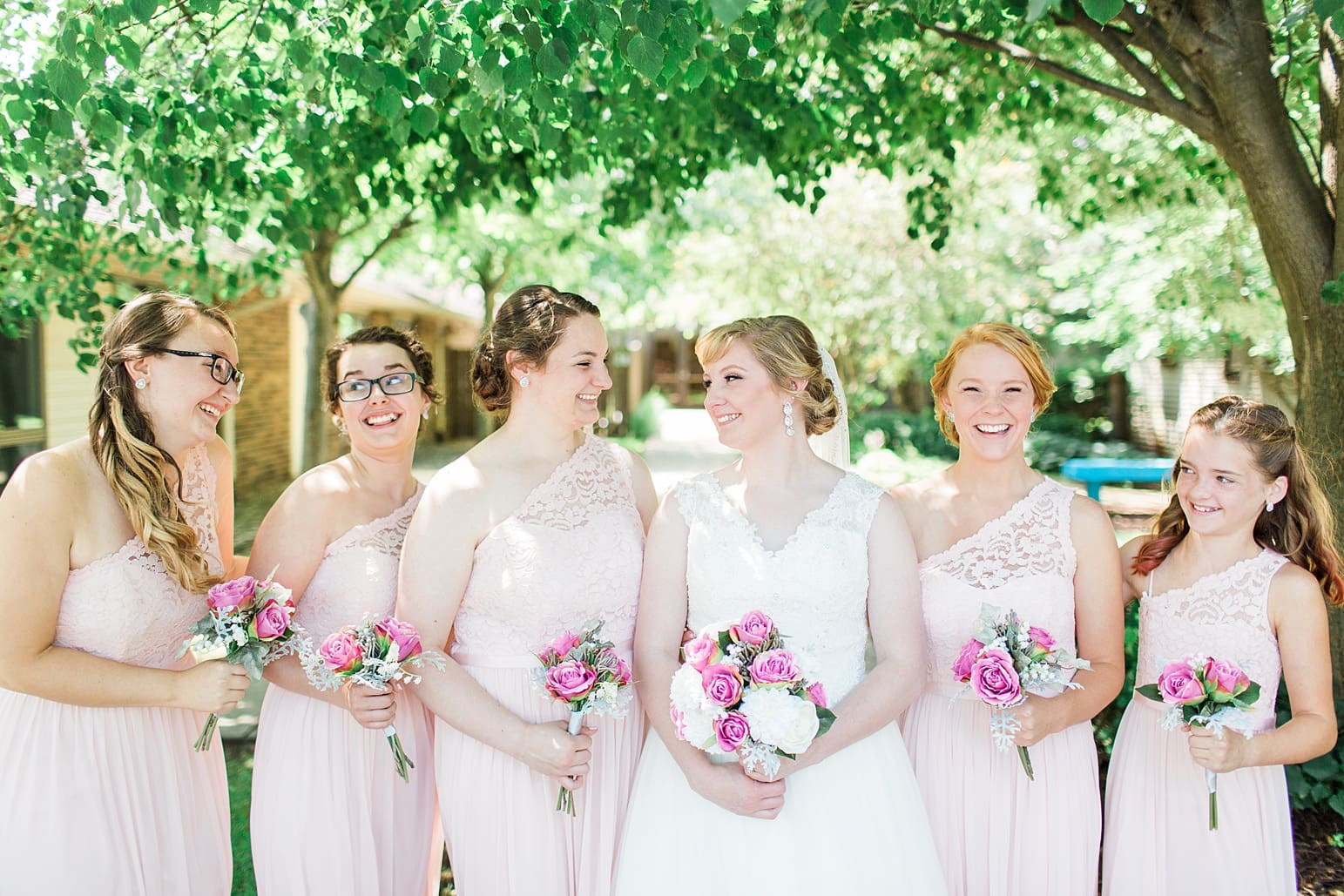 Arielle Peters Photography | Bride and bridesmaids outside under trees on wedding day at St. Joseph County Parks in South Bend, Indiana.