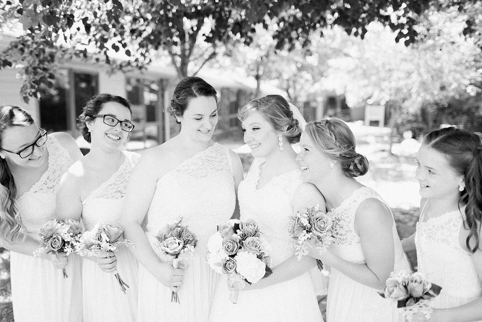 Arielle Peters Photography | Bride and bridesmaids outside under trees on wedding day at St. Joseph County Parks in South Bend, Indiana.