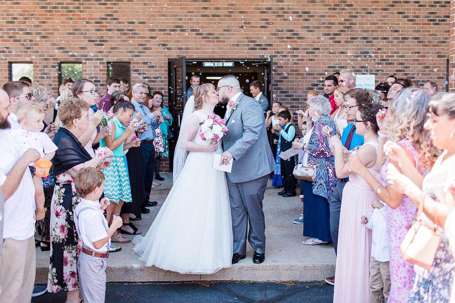 Arielle Peters Photography | Bride and groom kissing in bubble sendoff on wedding day at St. Joseph County Parks in South Bend, Indiana.