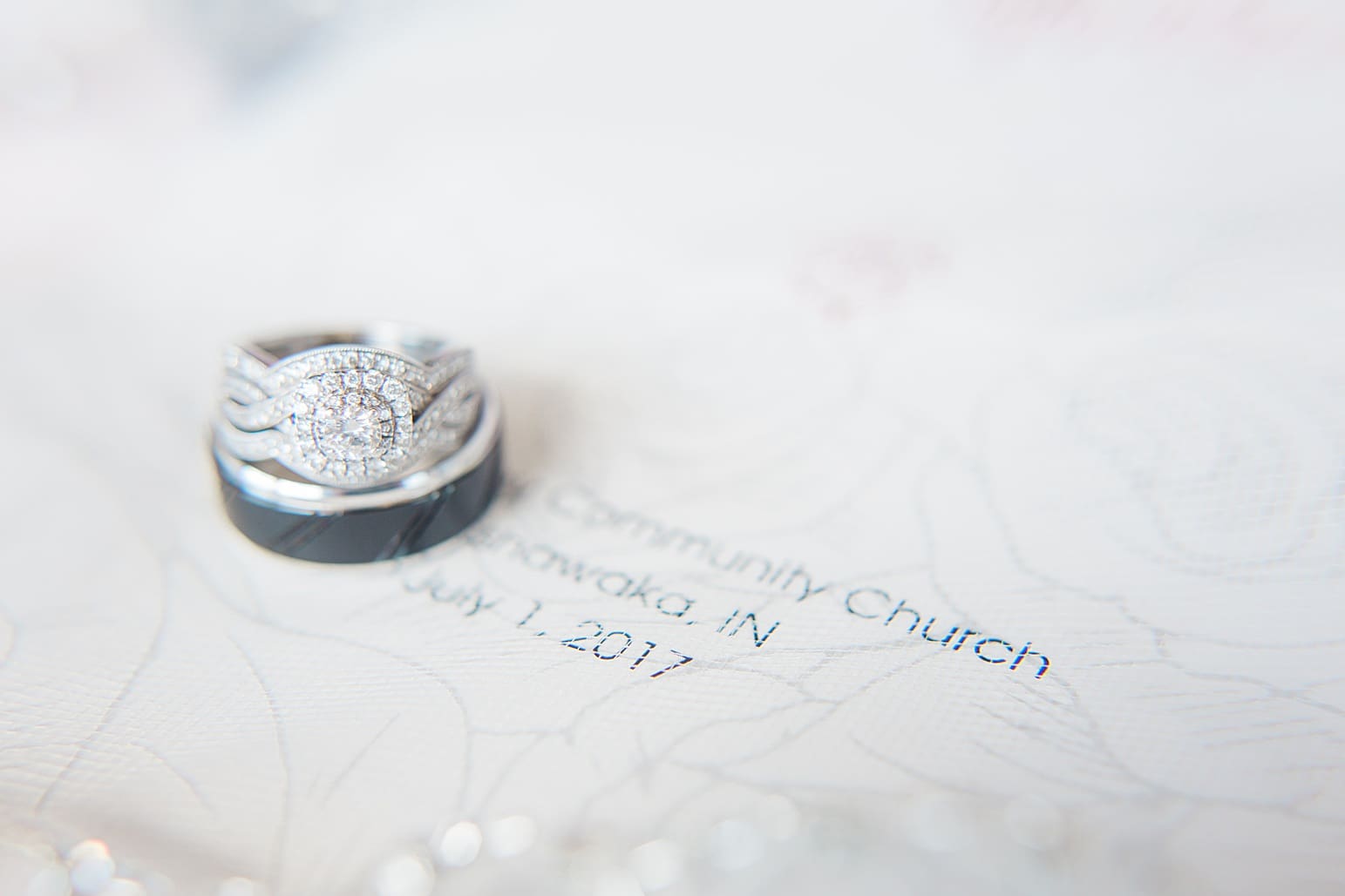 Arielle Peters Photography | Wedding rings on invitation on wedding day at St. Joseph County Parks in South Bend, Indiana.