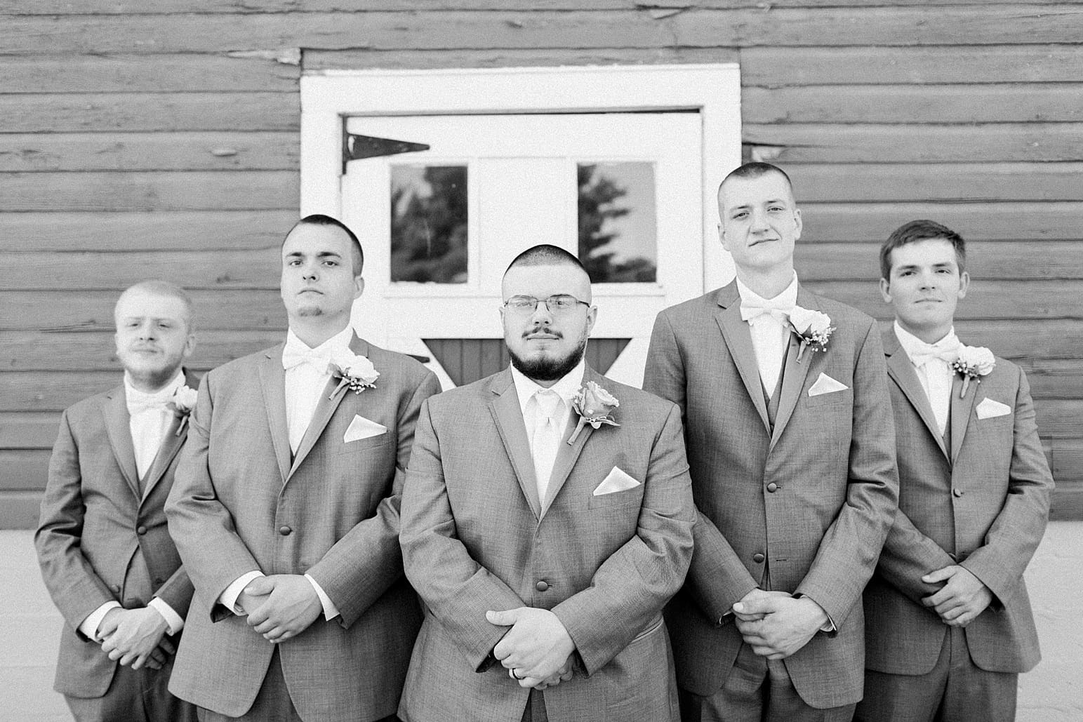 Arielle Peters Photography | Groom and groomsmen next to old red barn on wedding day at St. Joseph County Parks in South Bend, Indiana.