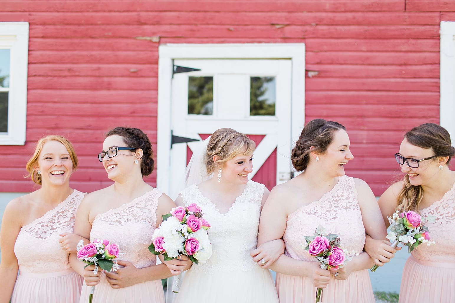 Arielle Peters Photography | Bride and bridesmaids next to old red barn on wedding day at St. Joseph County Parks in South Bend, Indiana.