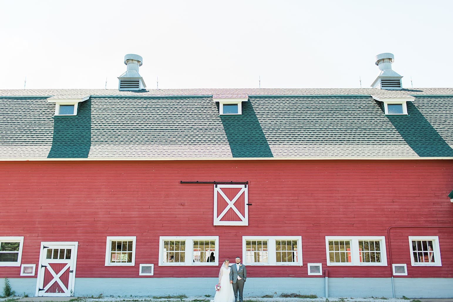 Arielle Peters Photography | Bride and groom next to old red barn on wedding day at St. Joseph County Parks in South Bend, Indiana.