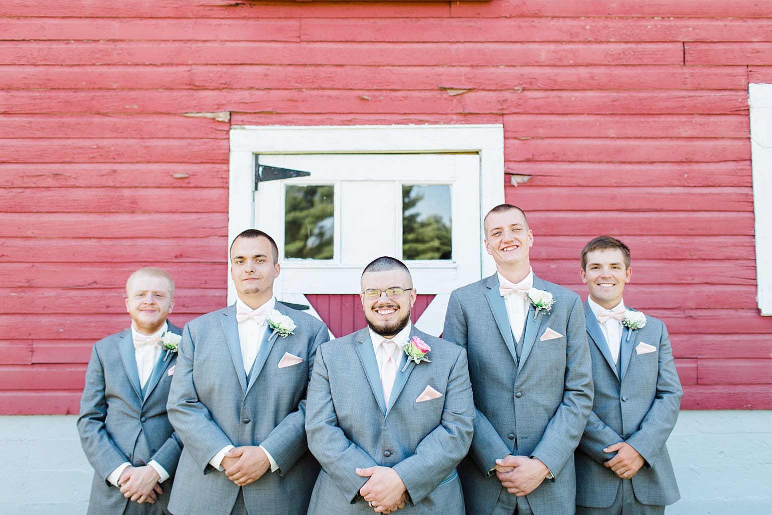 Arielle Peters Photography | Groom and groomsmen next to old red barn on wedding day at St. Joseph County Parks in South Bend, Indiana.