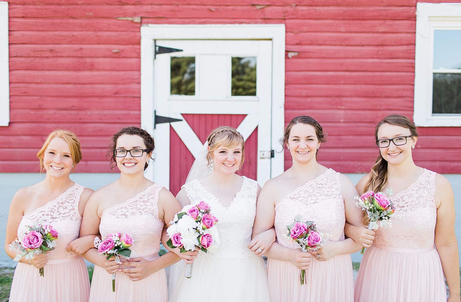 Arielle Peters Photography | Bride and bridesmaids next to old red barn on wedding day at St. Joseph County Parks in South Bend, Indiana.