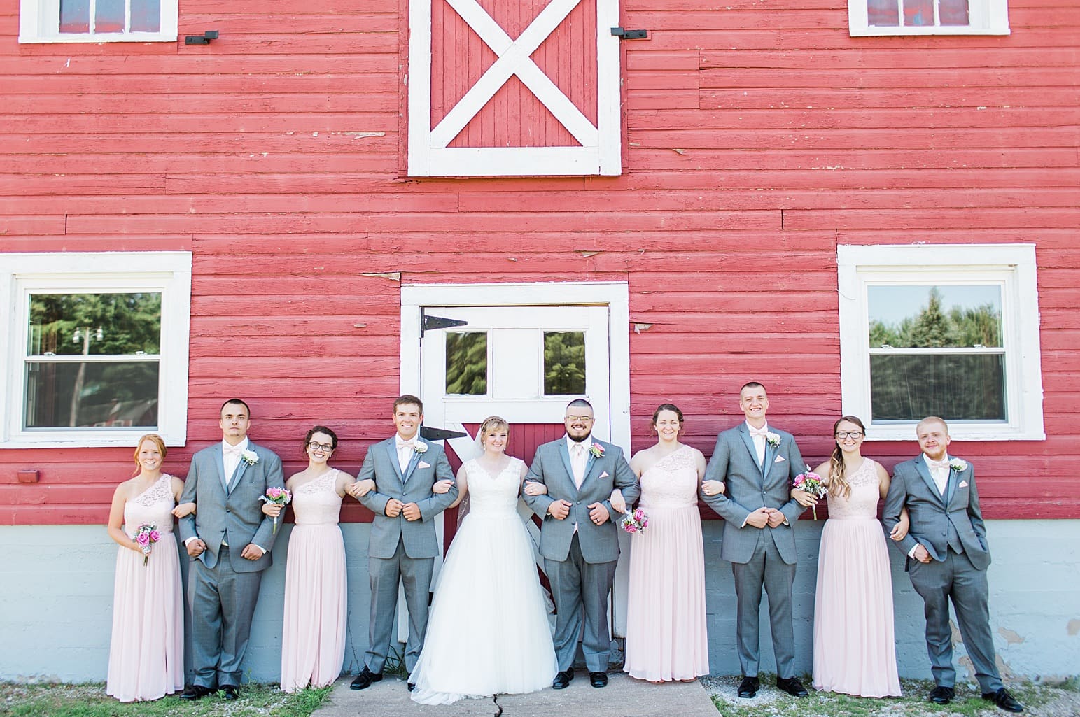 Arielle Peters Photography | Wedding party next to old red barn on wedding day at St. Joseph County Parks in South Bend, Indiana.
