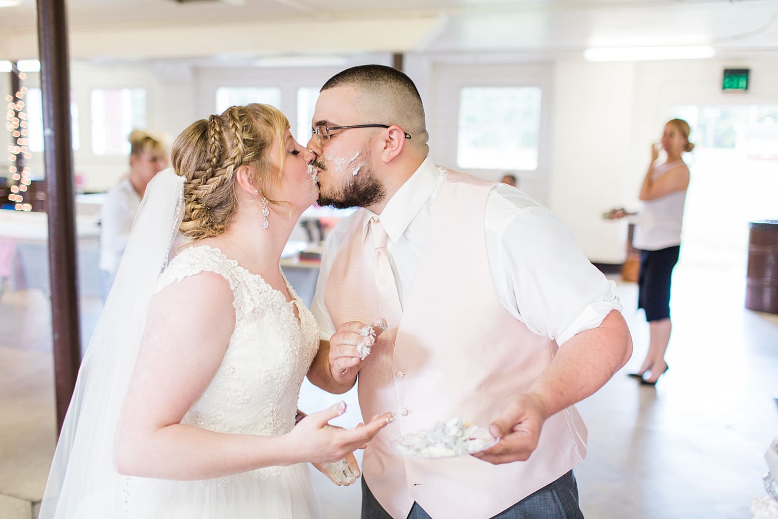 Arielle Peters Photography | Bride and groom feeding each other wedding cake on wedding day at St. Joseph County Parks in South Bend, Indiana.