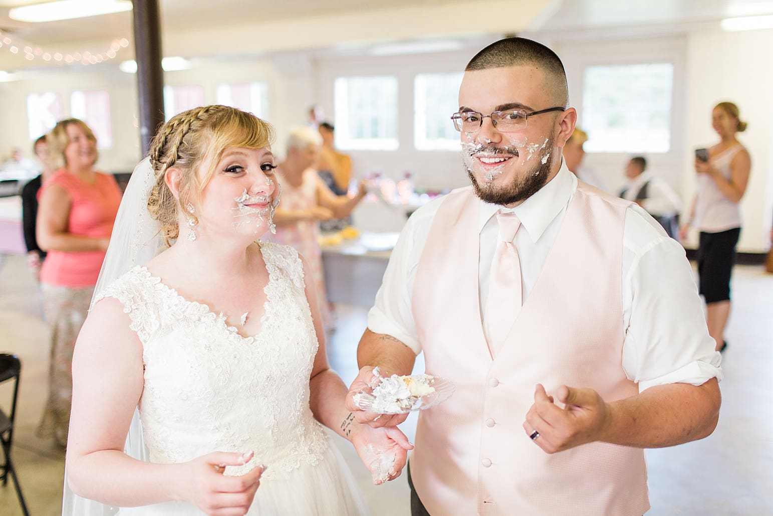 Arielle Peters Photography | Bride and groom with cake on their faces on wedding day at St. Joseph County Parks in South Bend, Indiana.