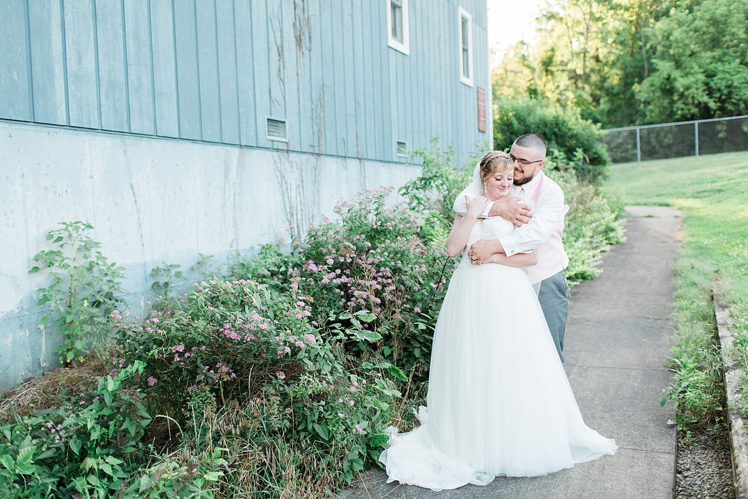 Arielle Peters Photography | Bride and groom outside blue barn on wedding day at St. Joseph County Parks in South Bend, Indiana.