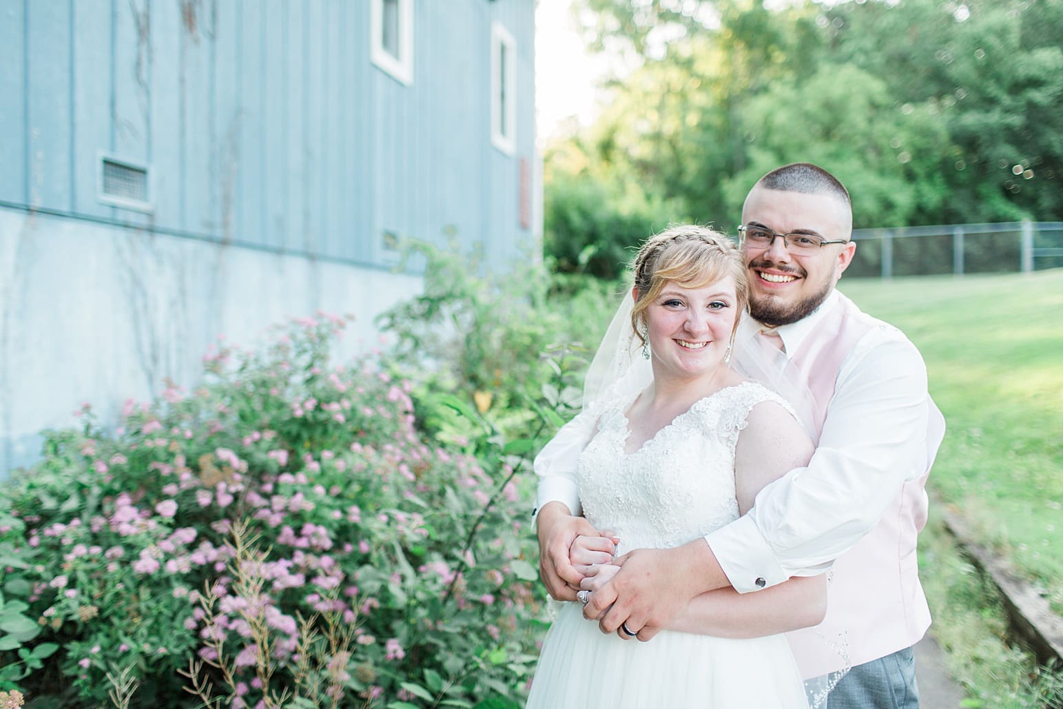 Arielle Peters Photography | Bride and groom outside blue barn on wedding day at St. Joseph County Parks in South Bend, Indiana.