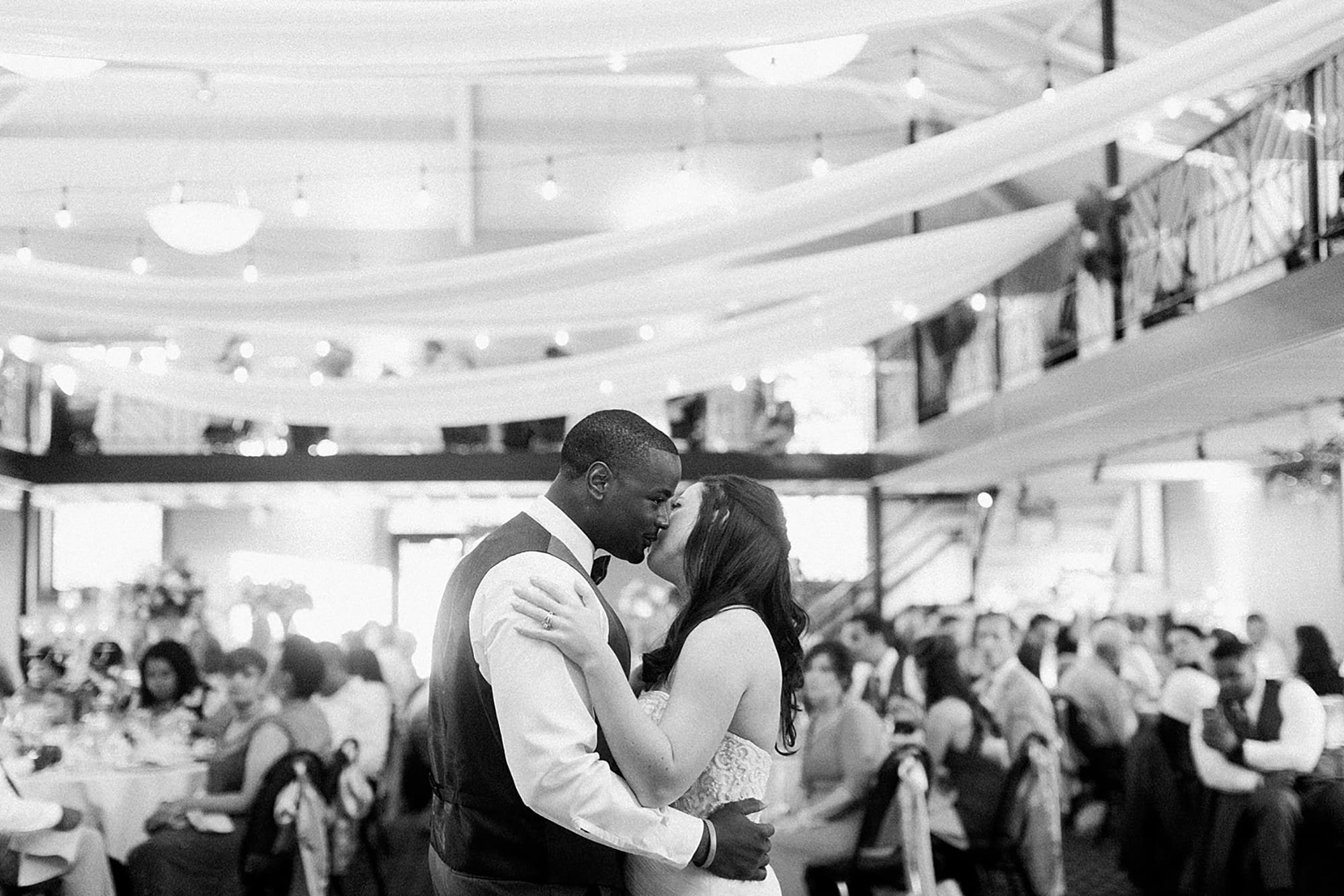 Arielle Peters Photography | Bride and groom kissing during first dance at wedding reception on wedding day at Nazareth Hall in Grand Rapids, Ohio. 