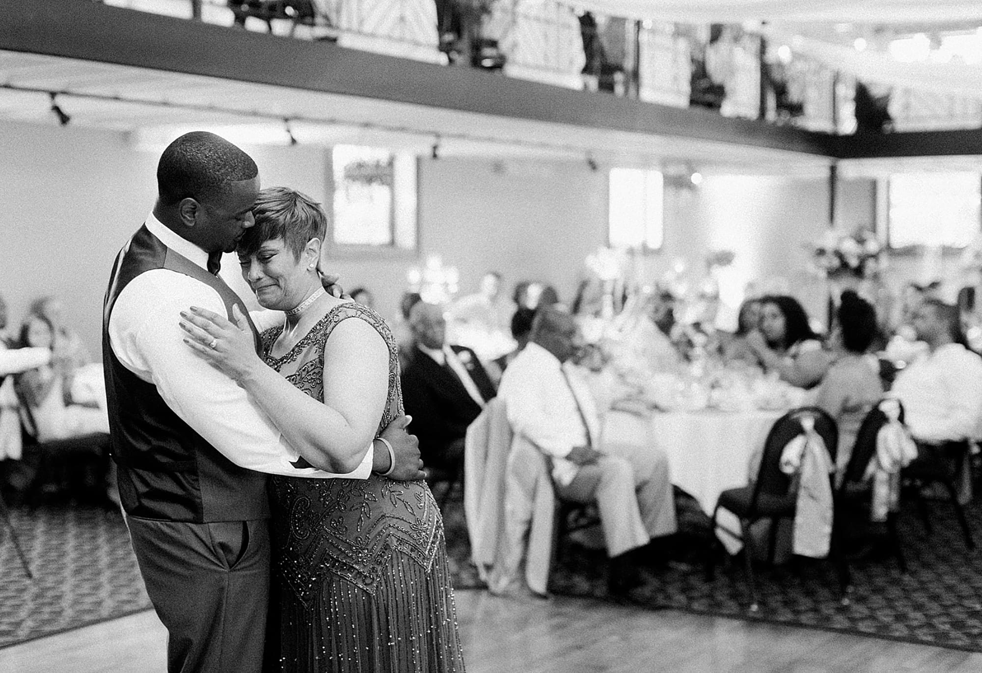 Arielle Peters Photography | Mother of groom and groom sharing a dance at wedding reception on wedding day at Nazareth Hall in Grand Rapids, Ohio. 