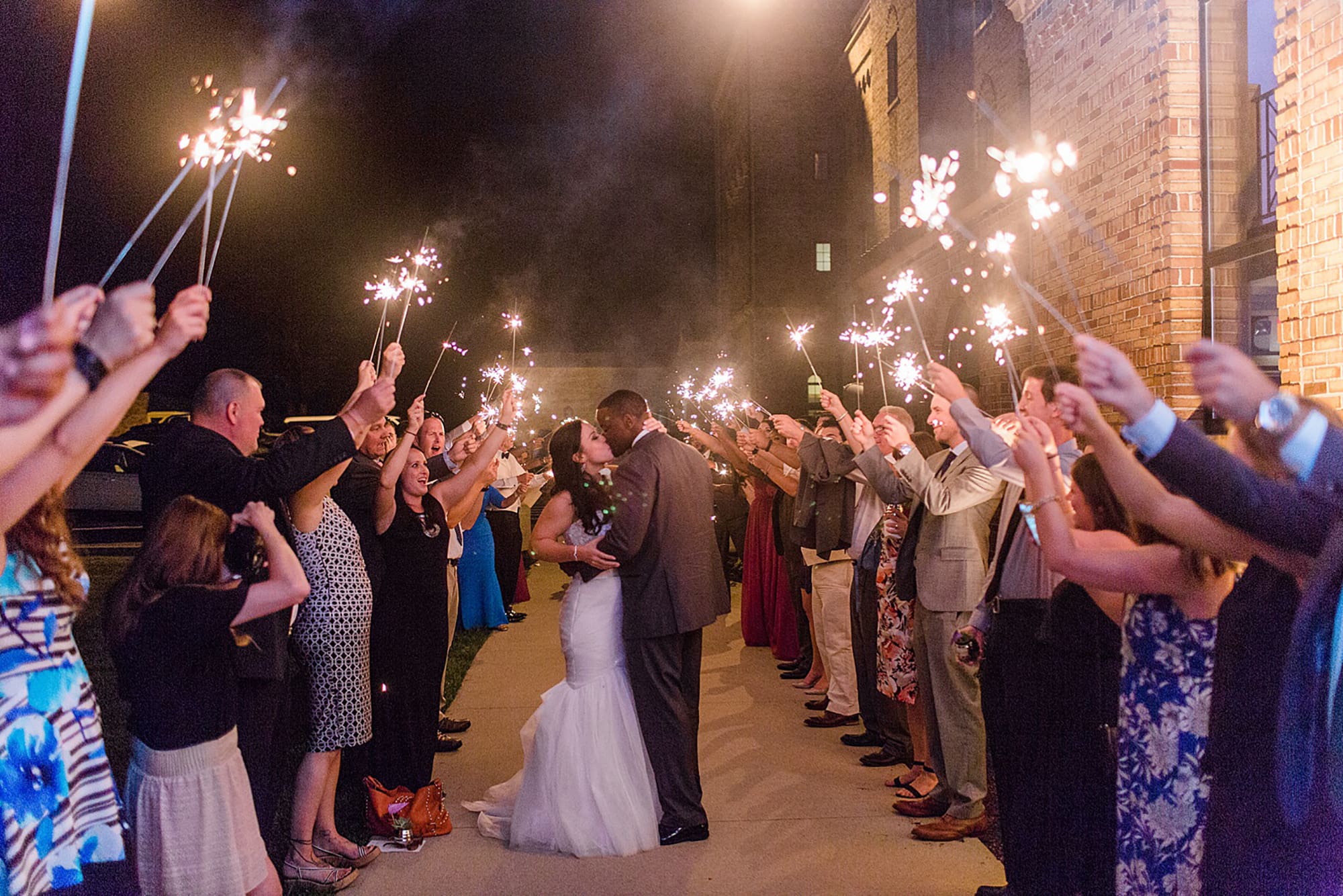 Arielle Peters Photography | Bride and groom kissing under sparkler send off at wedding reception on wedding day at Nazareth Hall in Grand Rapids, Ohio. 
