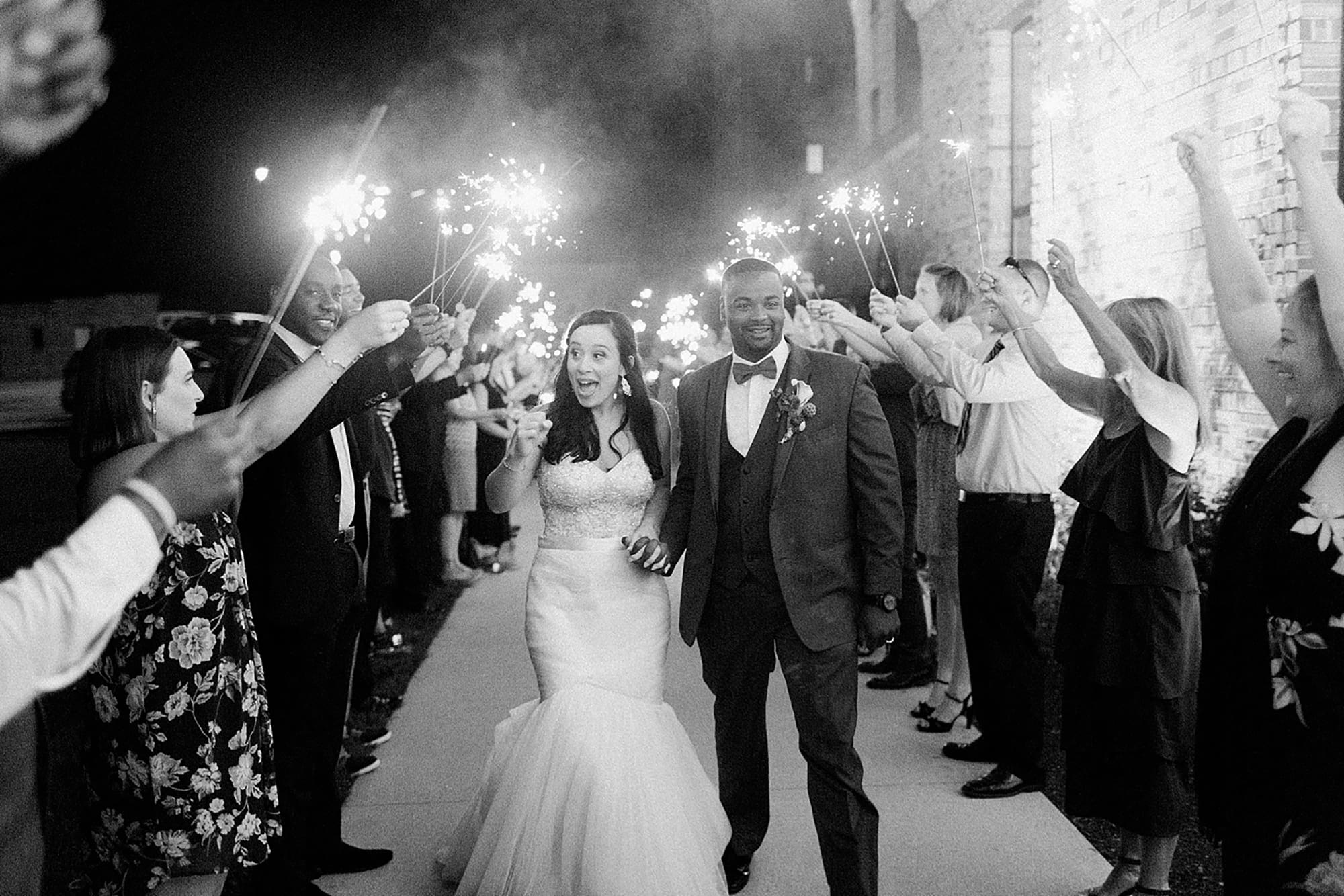 Arielle Peters Photography | Bride and groom walking through sparkler send off at wedding reception on wedding day at Nazareth Hall in Grand Rapids, Ohio. 