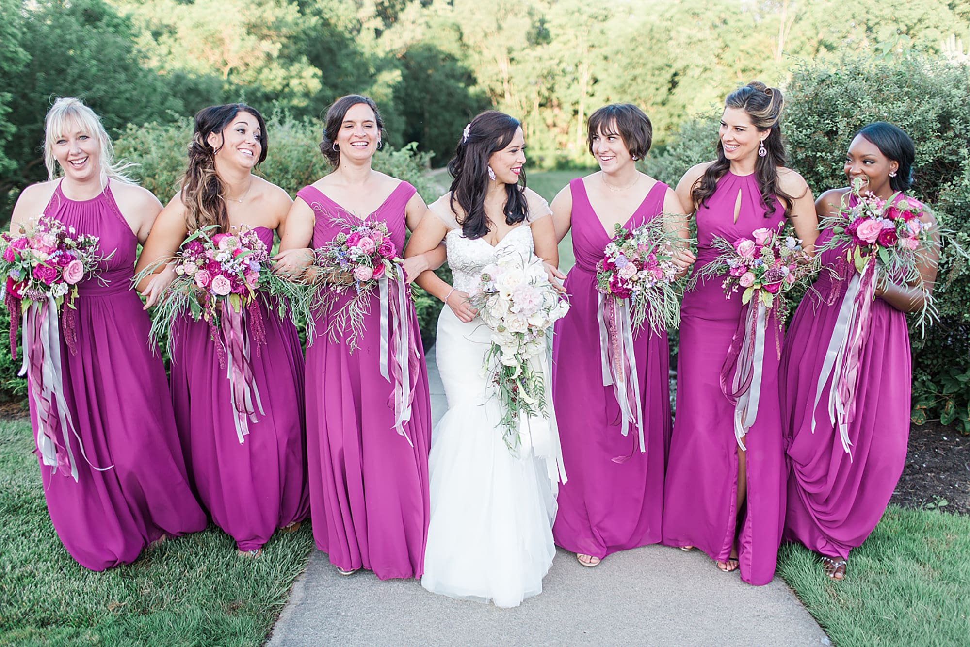 Arielle Peters Photography | Bride and bridesmaids walking in park on wedding day photos at Nazareth Hall in Grand Rapids, Ohio. 