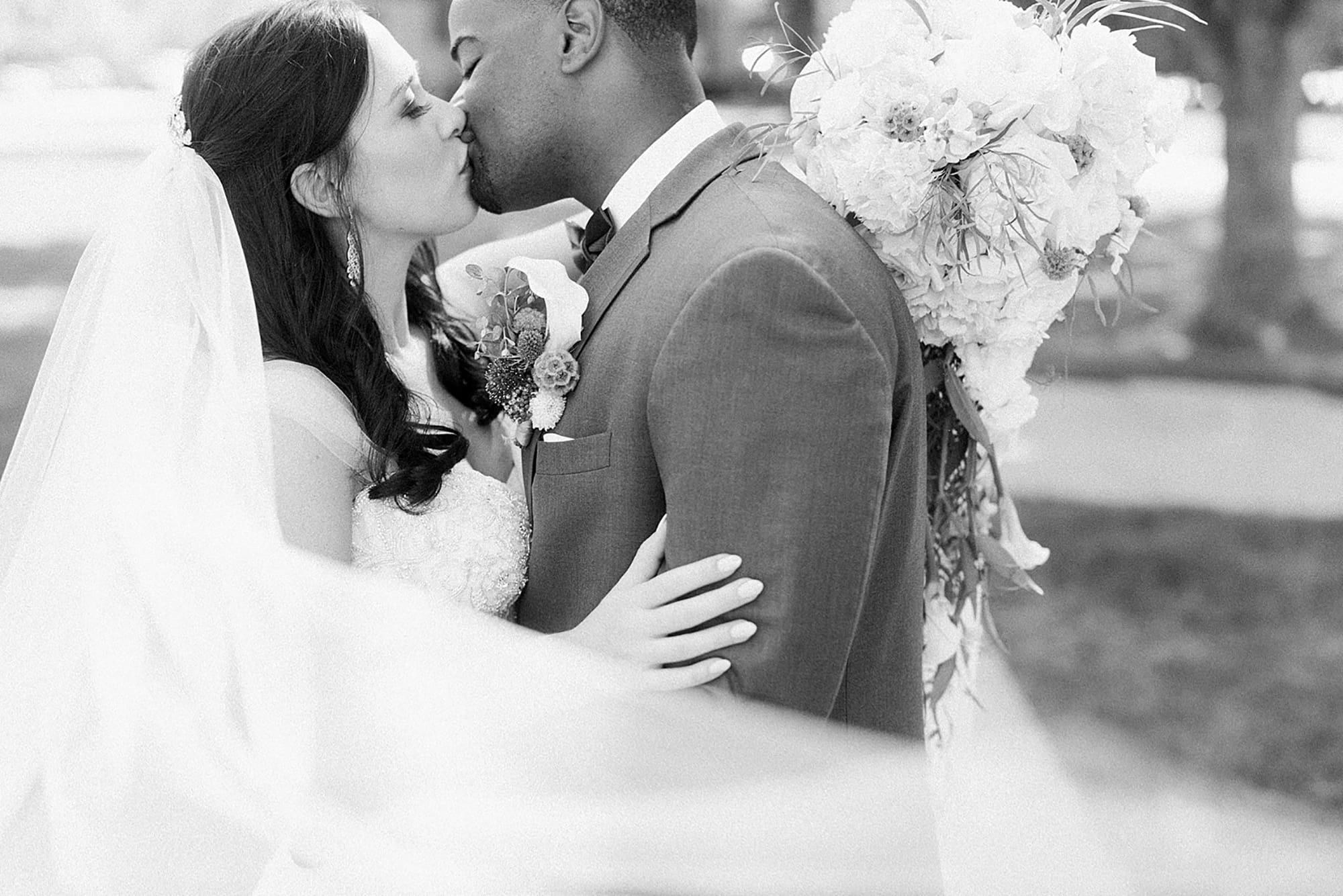 Arielle Peters Photography | Bride and groom kissing in garden on wedding day photos at Nazareth Hall in Grand Rapids, Ohio. 