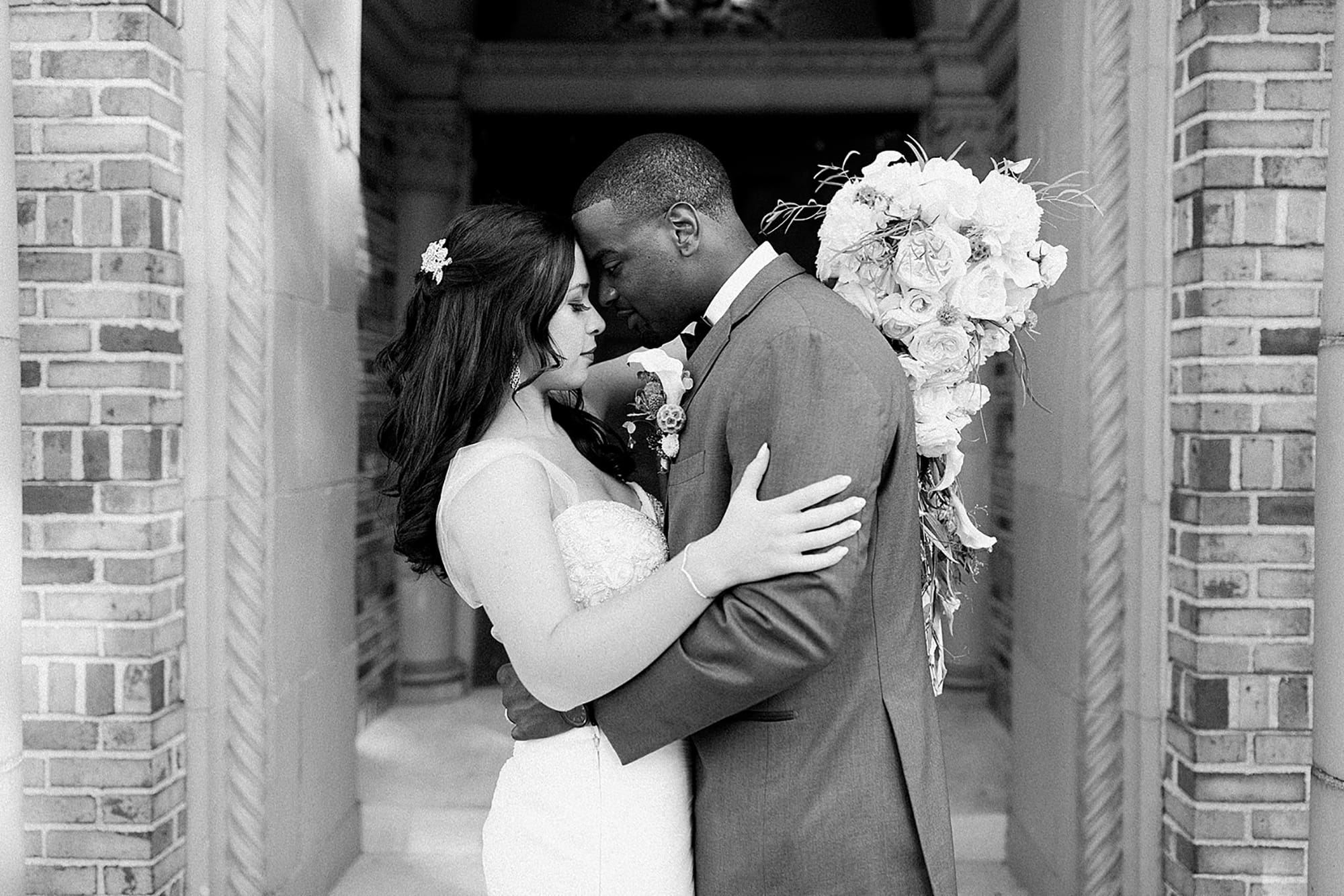 Arielle Peters Photography | Bride and groom under brick archway on wedding day photos at Nazareth Hall in Grand Rapids, Ohio. 