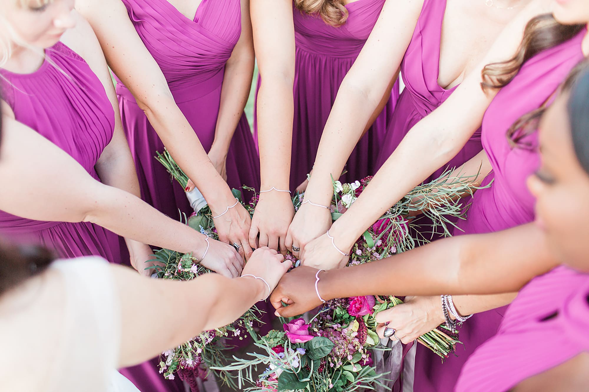 Arielle Peters Photography | Bride and bridesmaids with hands in circle on wedding day photos at Nazareth Hall in Grand Rapids, Ohio. 