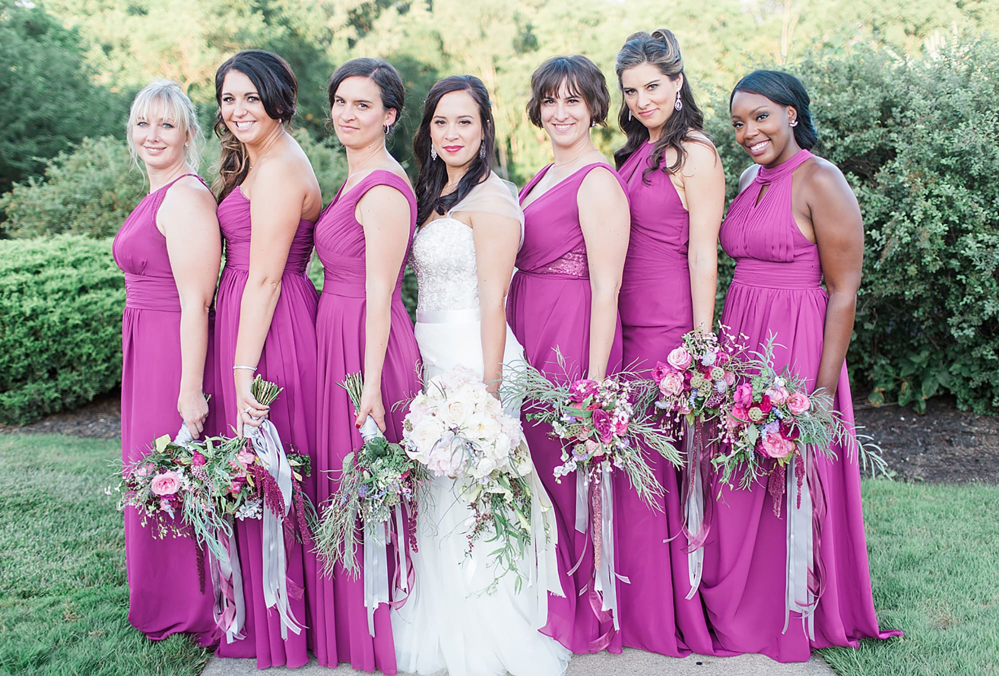 Arielle Peters Photography | Bride and bridesmaids holding bouquets in park on wedding day photos at Nazareth Hall in Grand Rapids, Ohio. 