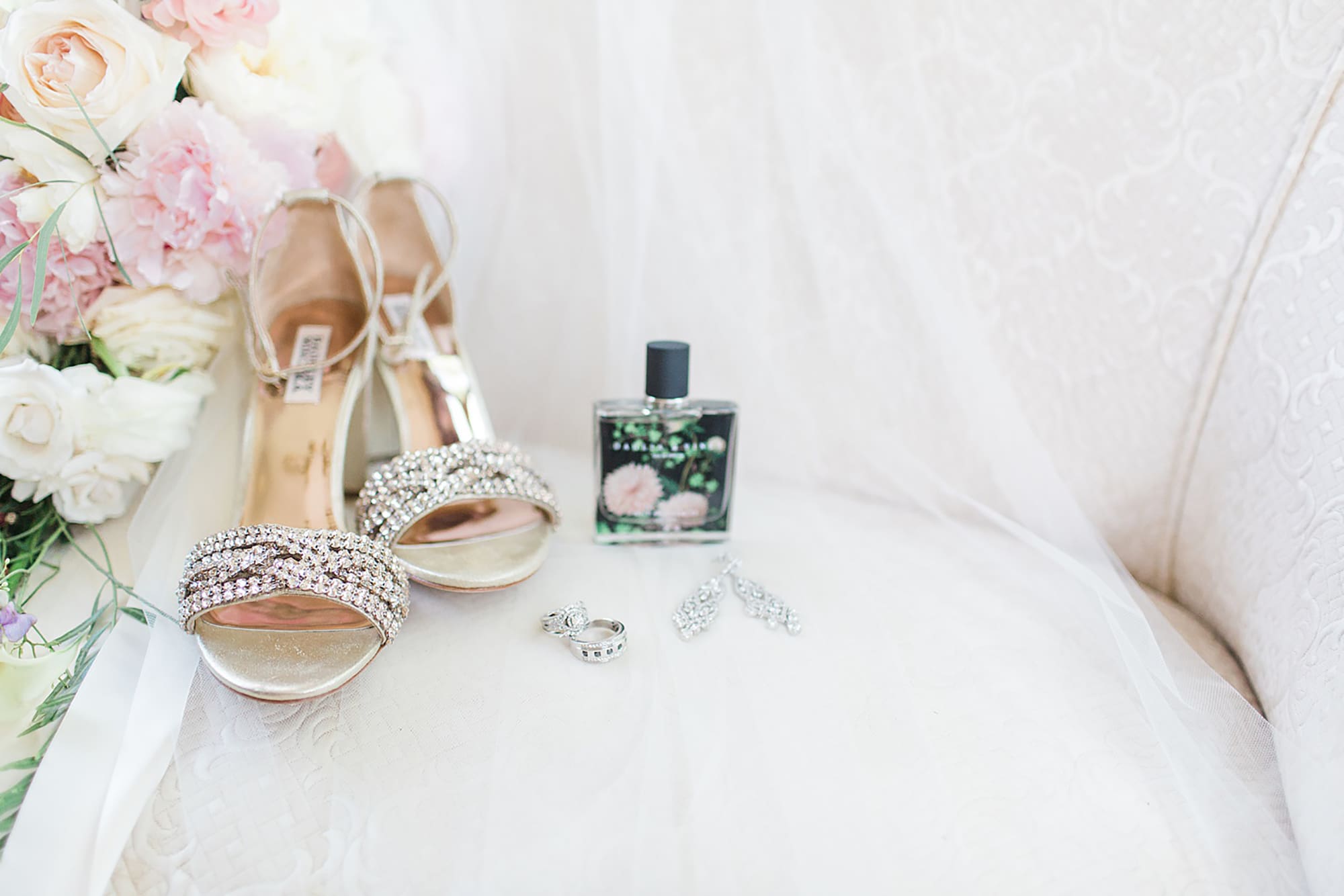 Arielle Peters Photography | Bride shoes and perfume on white couch on wedding day photos at Nazareth Hall in Grand Rapids, Ohio. 