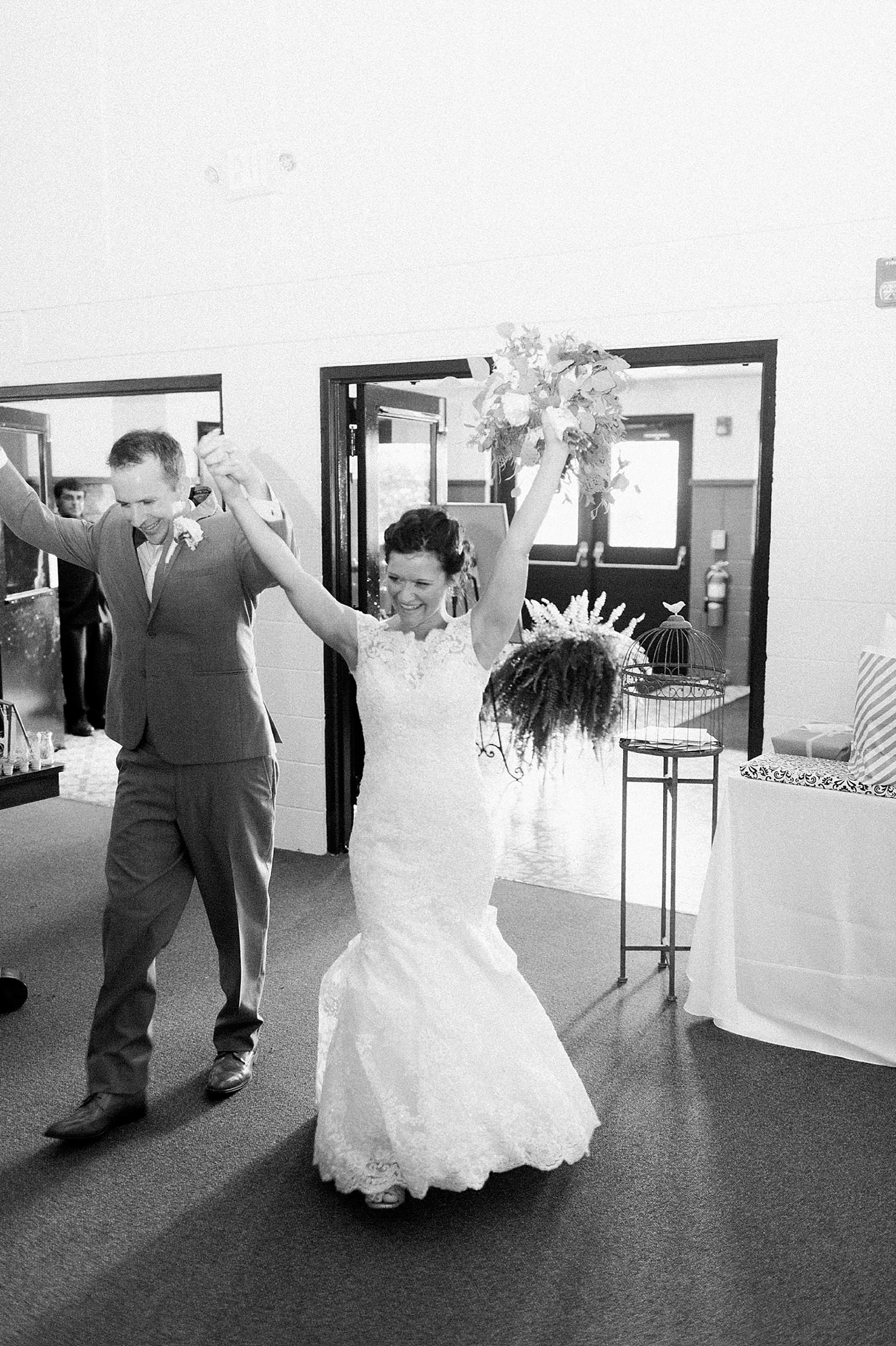 Arielle Peters Photography | Bride and groom entering wedding reception on wedding day at Winona Heritage Room in Winona Lake, Indiana.