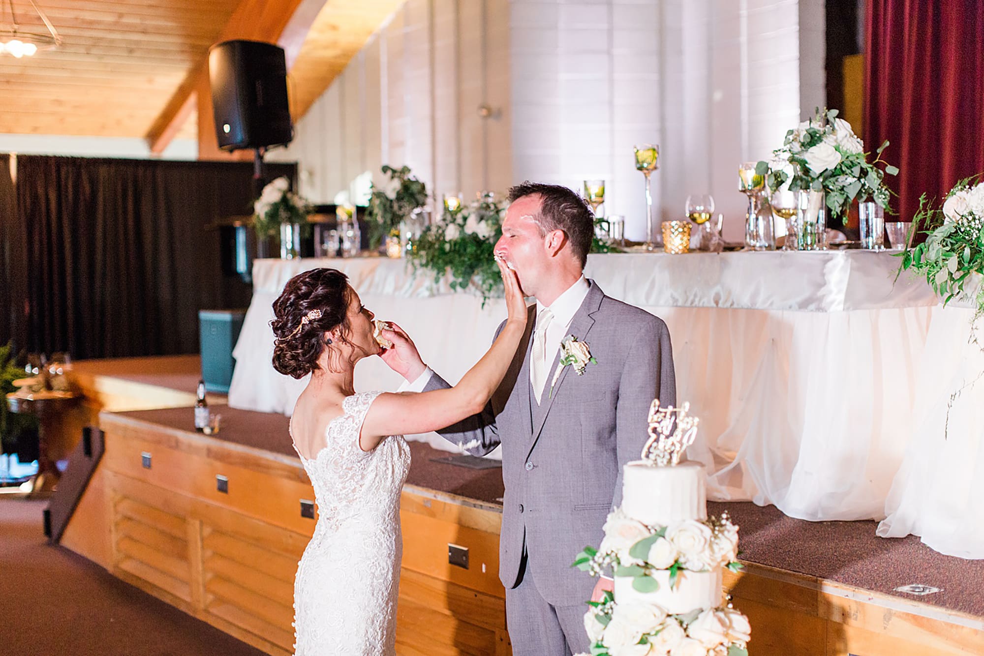 Arielle Peters Photography | Bride and groom feeding each other wedding cake on wedding day at Winona Heritage Room in Winona Lake, Indiana.