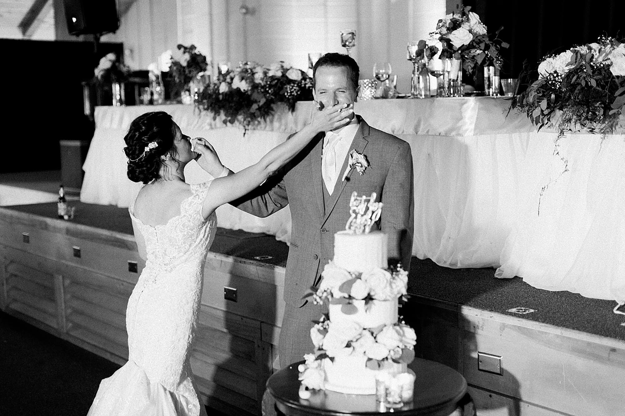Arielle Peters Photography | Bride and groom feeding each other wedding cake on wedding day at Winona Heritage Room in Winona Lake, Indiana.
