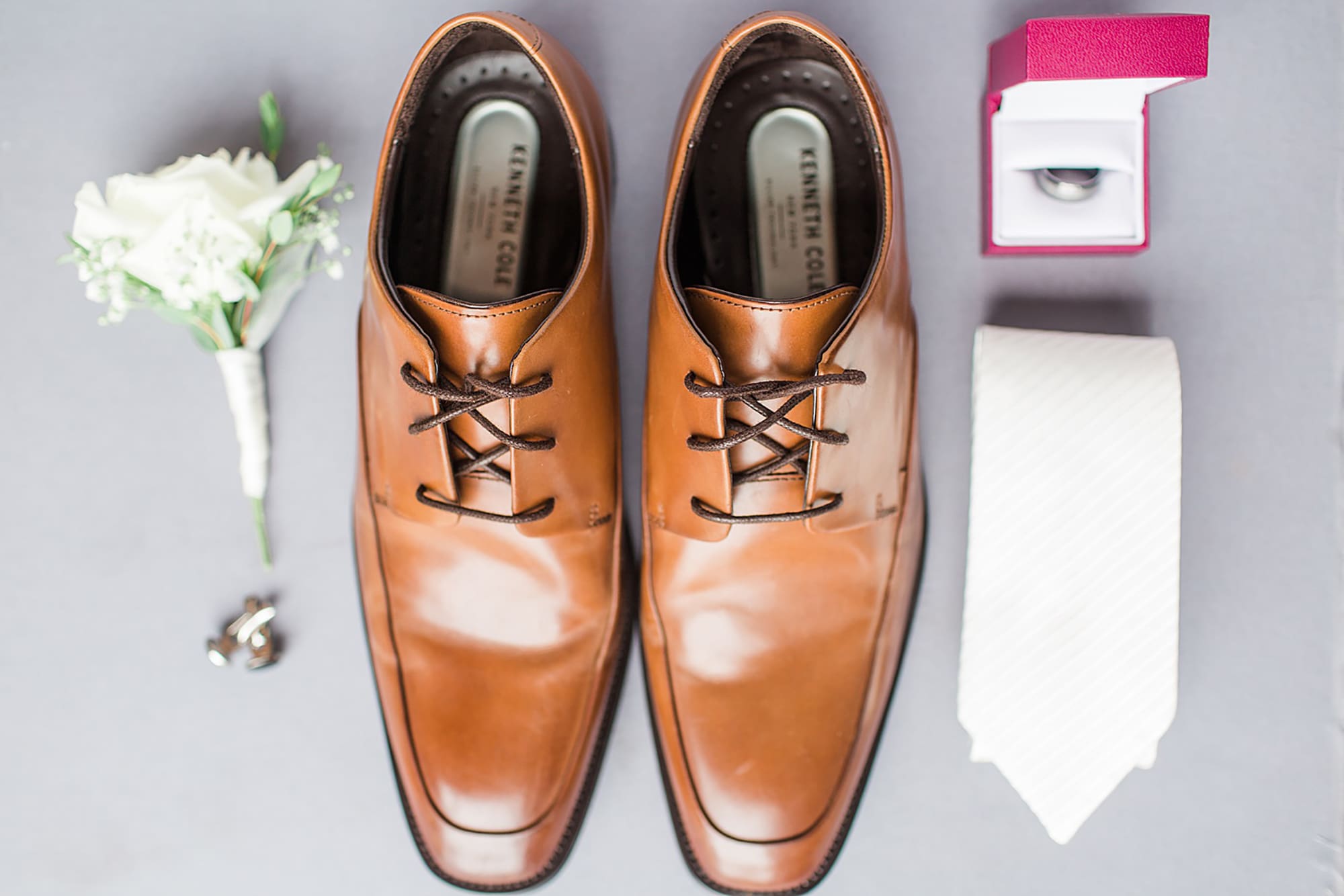 Arielle Peters Photography | Groom's shoes and tie on gray background on wedding day at Winona Heritage Room in Winona Lake, Indiana.