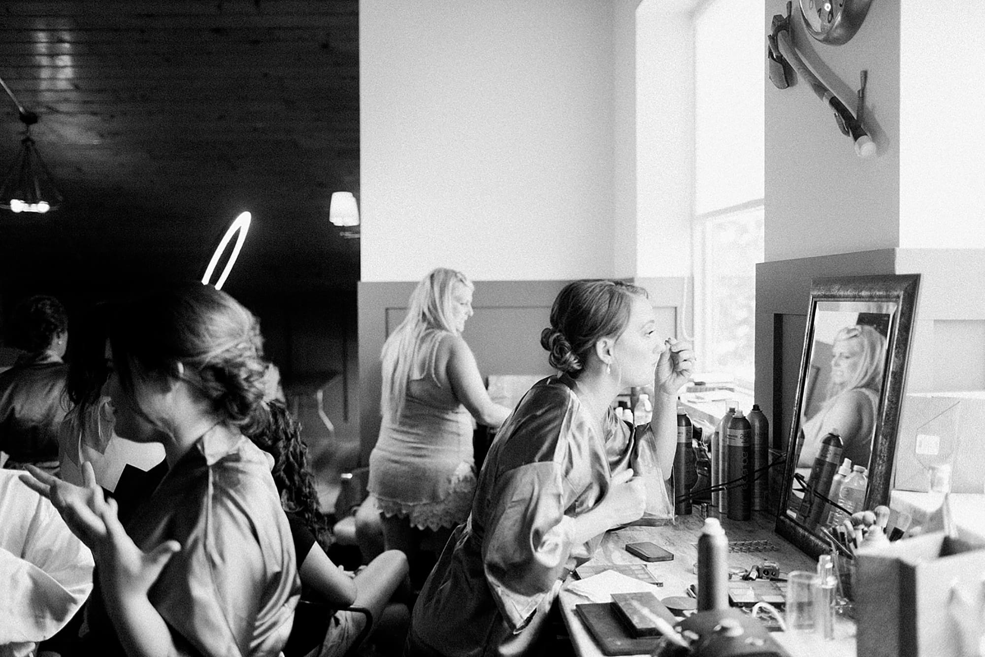 Arielle Peters Photography | Bride and bridesmaids putting on makeup on wedding day at Winona Heritage Room in Winona Lake, Indiana.