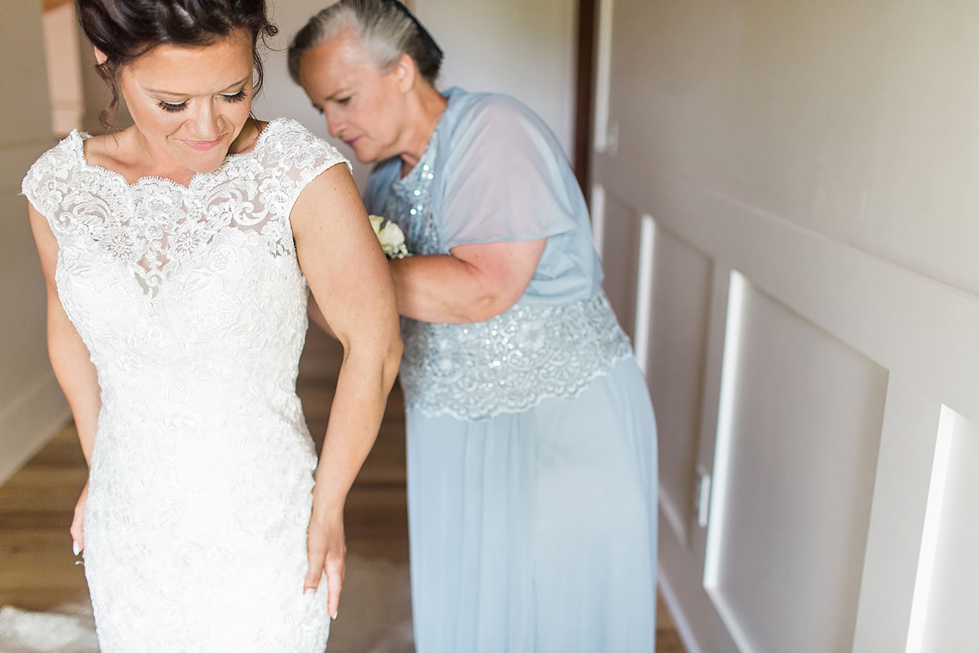Arielle Peters Photography | Mother of bride helping bride get ready on wedding day at Winona Heritage Room in Winona Lake, Indiana.