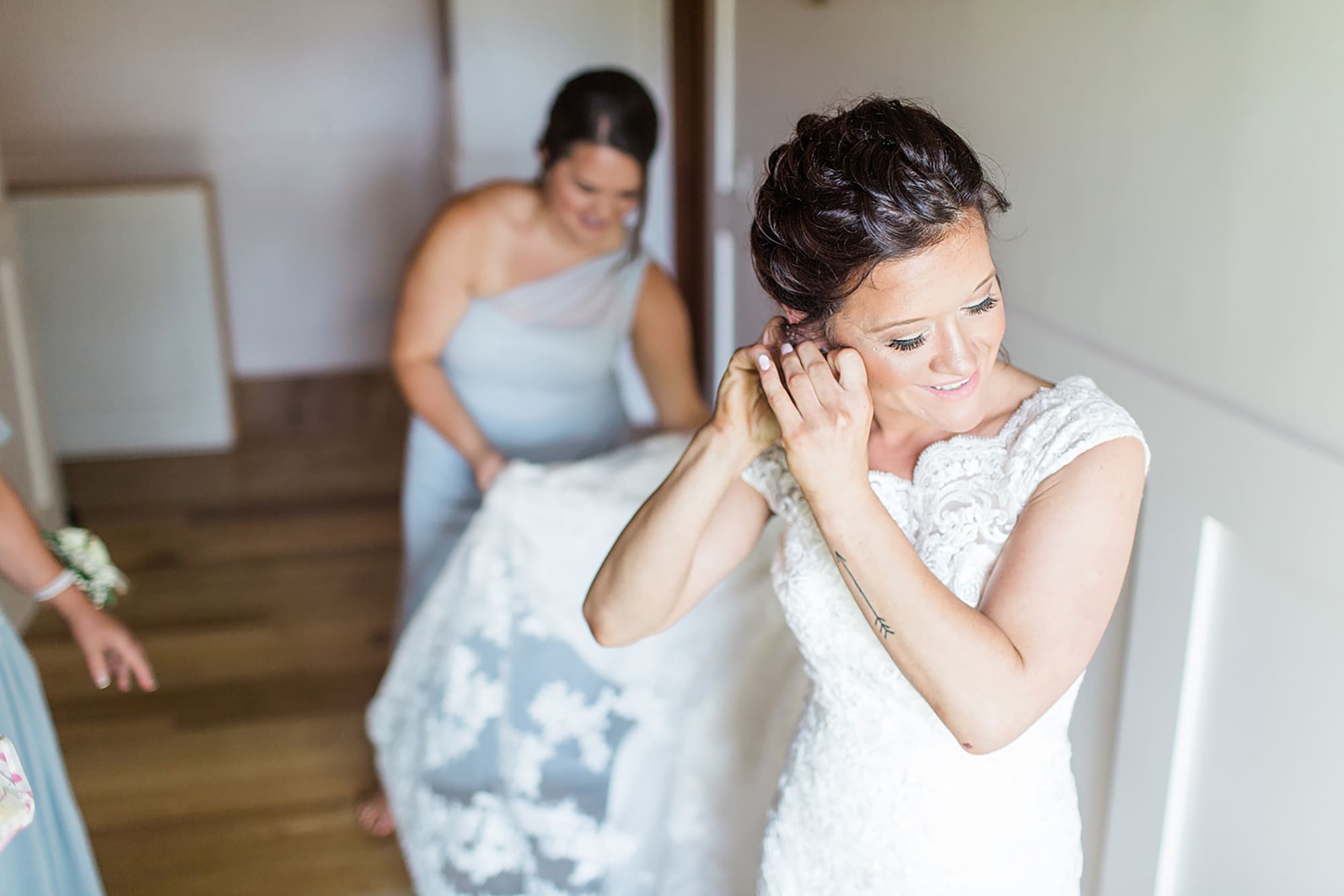 Arielle Peters Photography | Bride putting on wedding jewelry on wedding day at Winona Heritage Room in Winona Lake, Indiana.