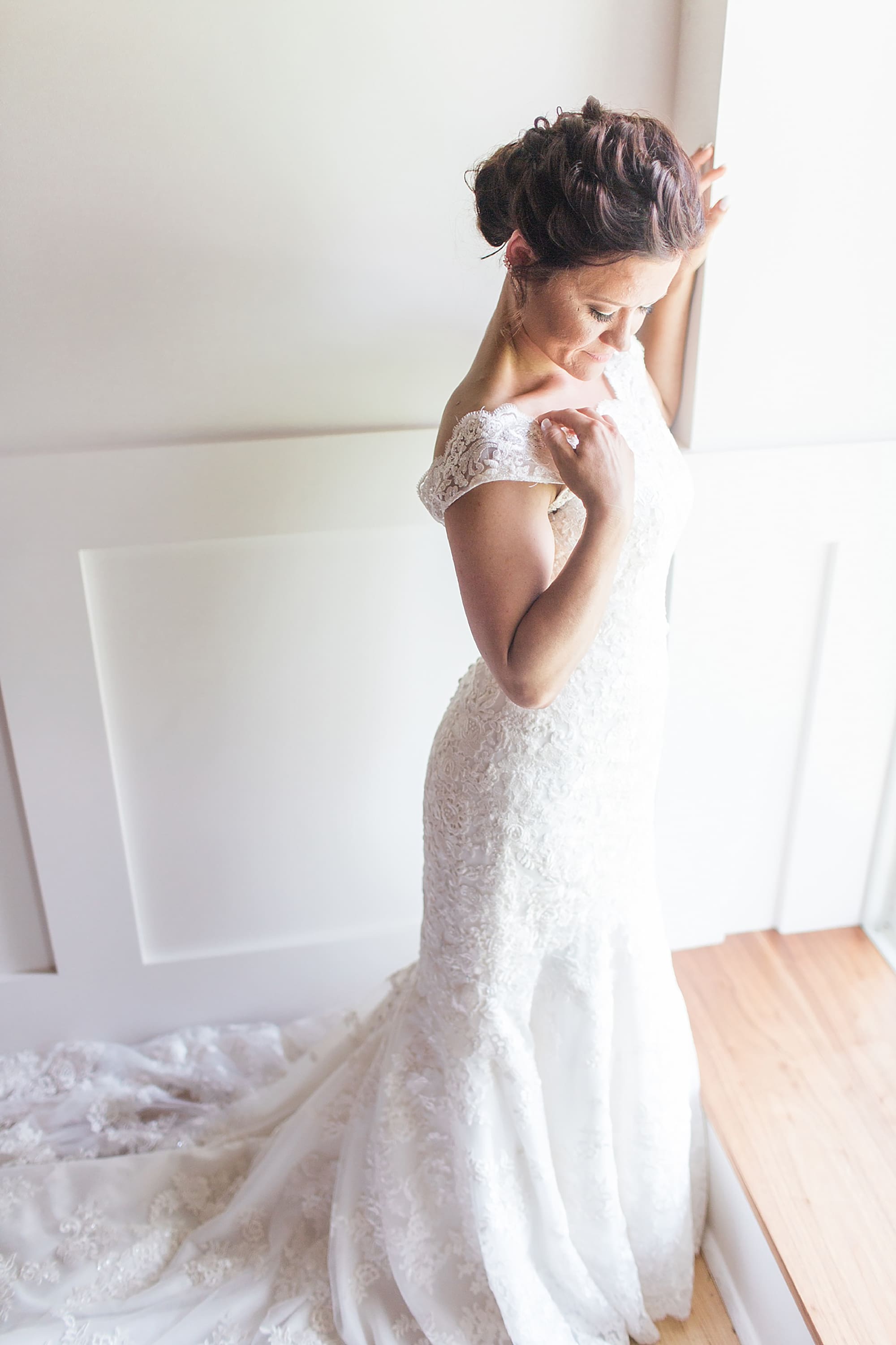 Arielle Peters Photography | Bride in wedding dress next to large window on wedding day at Winona Heritage Room in Winona Lake, Indiana.