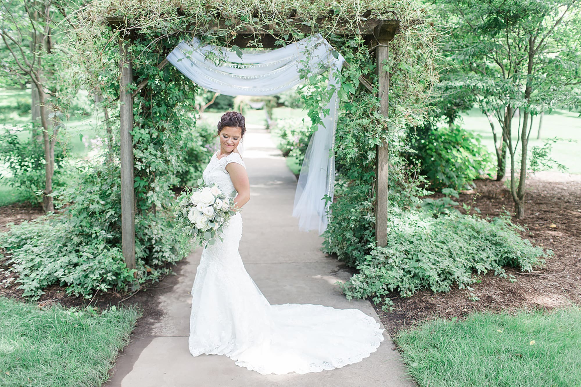 Arielle Peters Photography | Bride under garden terrace on wedding day at Winona Heritage Room in Winona Lake, Indiana.