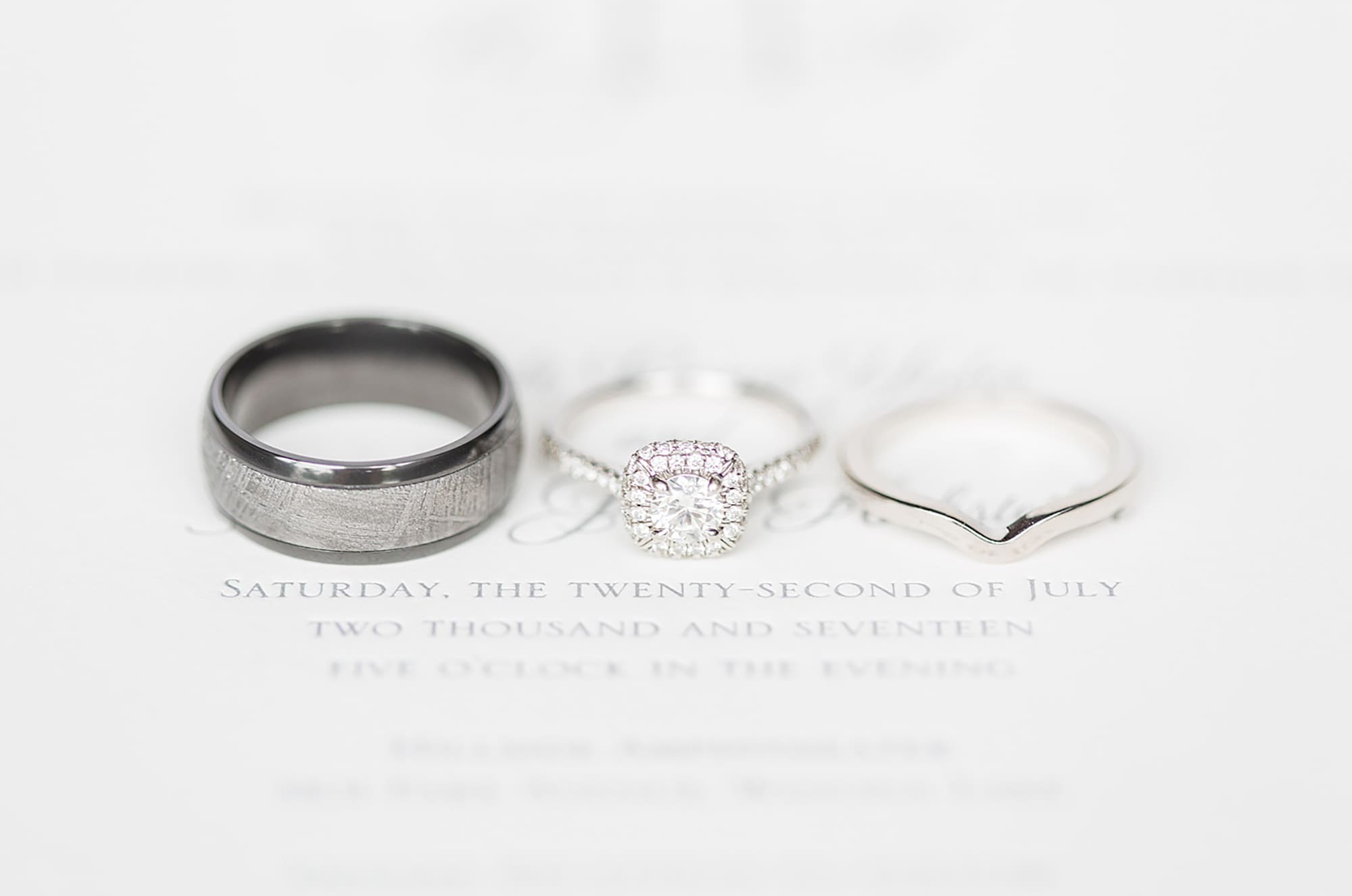 Arielle Peters Photography | Wedding rings on invitation on wedding day at Winona Heritage Room in Winona Lake, Indiana.