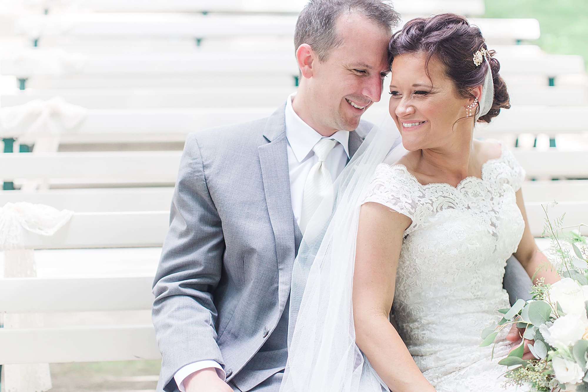 Arielle Peters Photography | Bride and groom on park bench on wedding day at Winona Heritage Room in Winona Lake, Indiana.