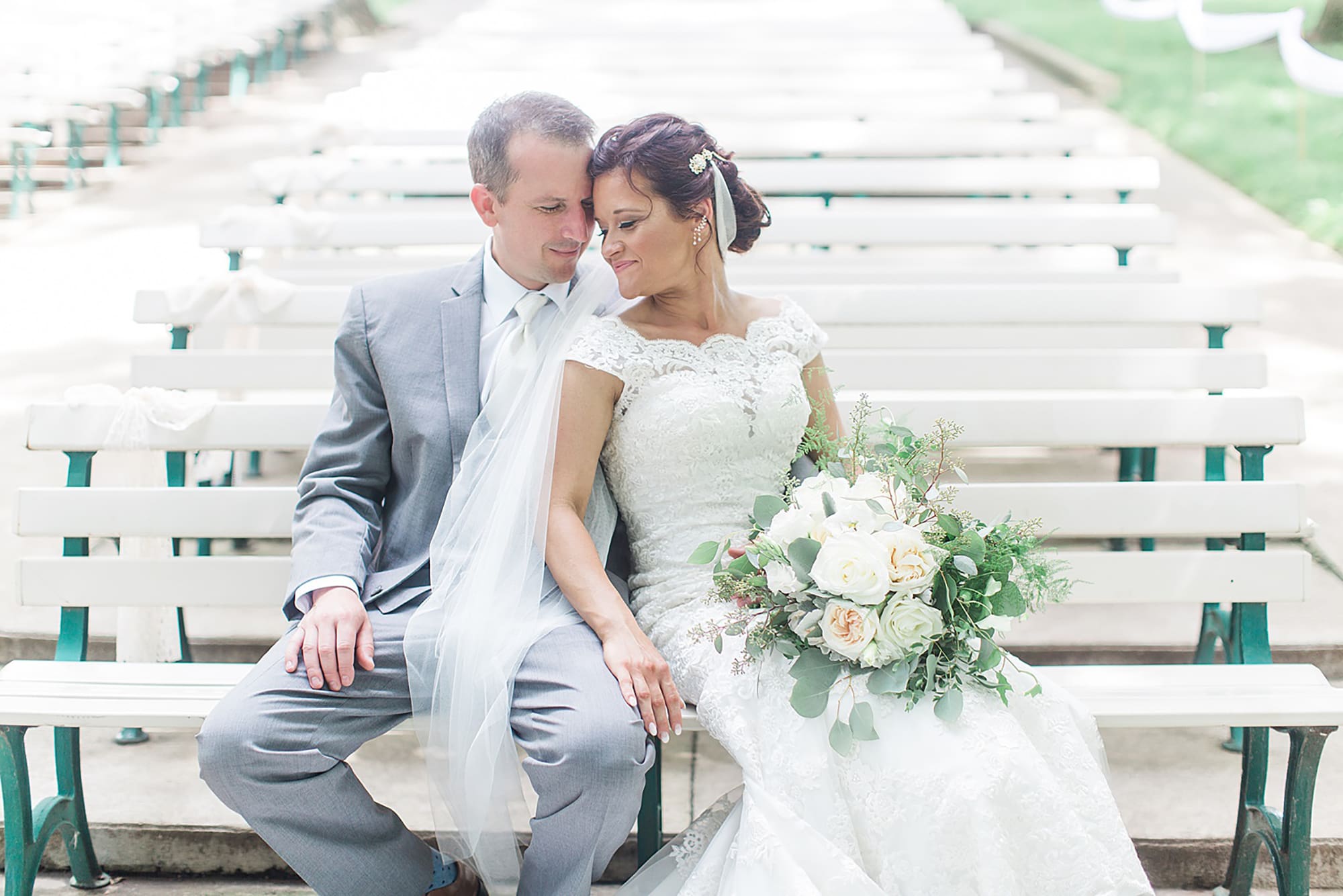 Arielle Peters Photography | Bride and groom on park bench on wedding day at Winona Heritage Room in Winona Lake, Indiana.
