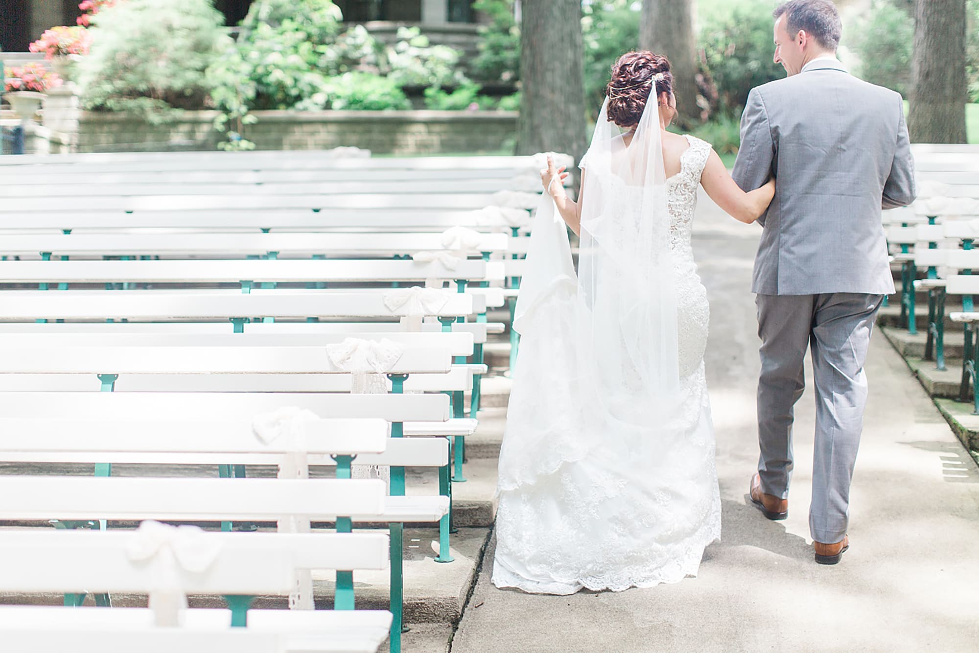 Arielle Peters Photography | Bride and groom walking in park on wedding day at Winona Heritage Room in Winona Lake, Indiana.