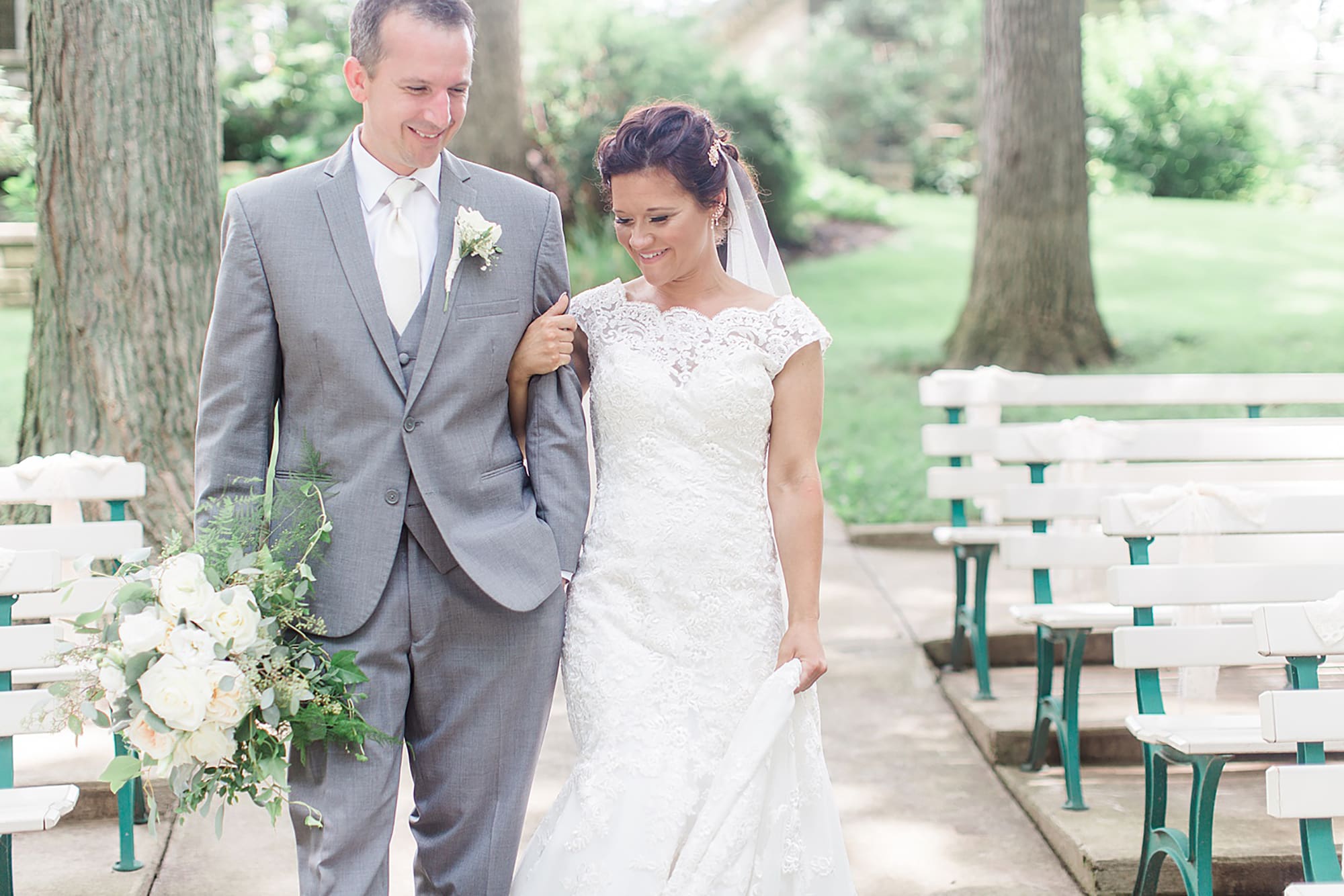 Arielle Peters Photography | Bride and groom walking in park on wedding day at Winona Heritage Room in Winona Lake, Indiana.