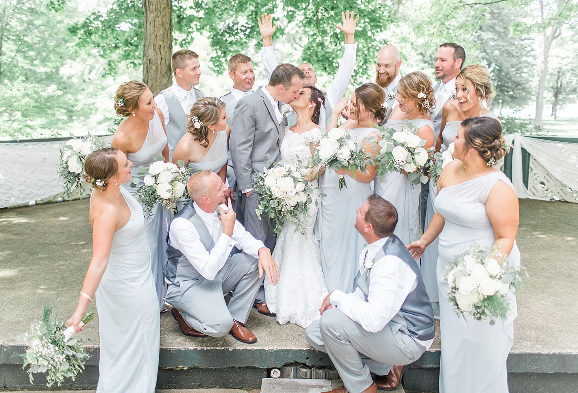 Arielle Peters Photography | Wedding party cheering in park on wedding day at Winona Heritage Room in Winona Lake, Indiana.