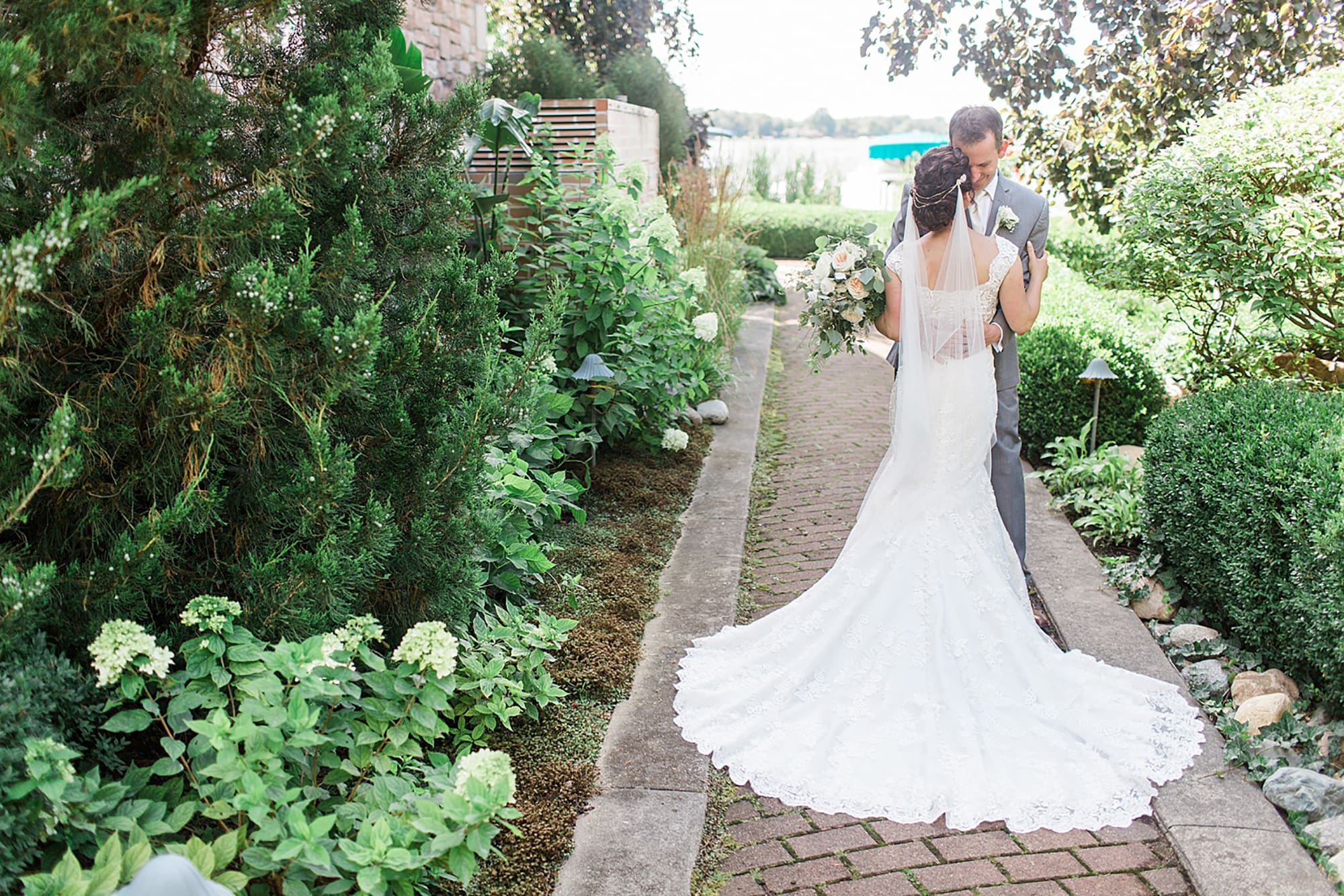 Arielle Peters Photography | Bride and groom on garden path on wedding day at Winona Heritage Room in Winona Lake, Indiana.